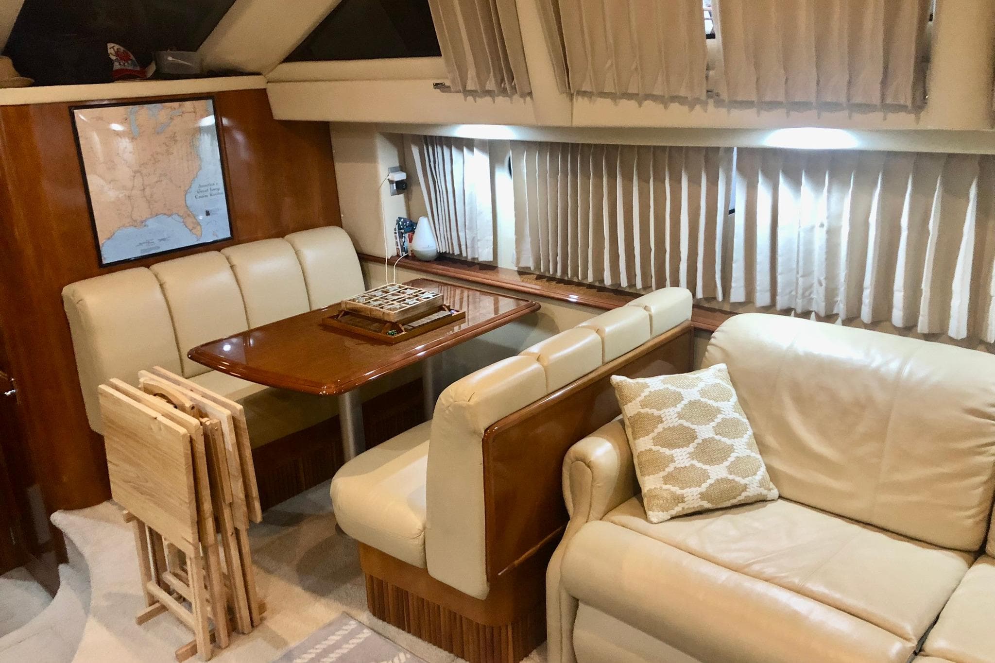 Luxurious interior of 2005 Carver 444 Cockpit Motor Yacht with dining area and seating.