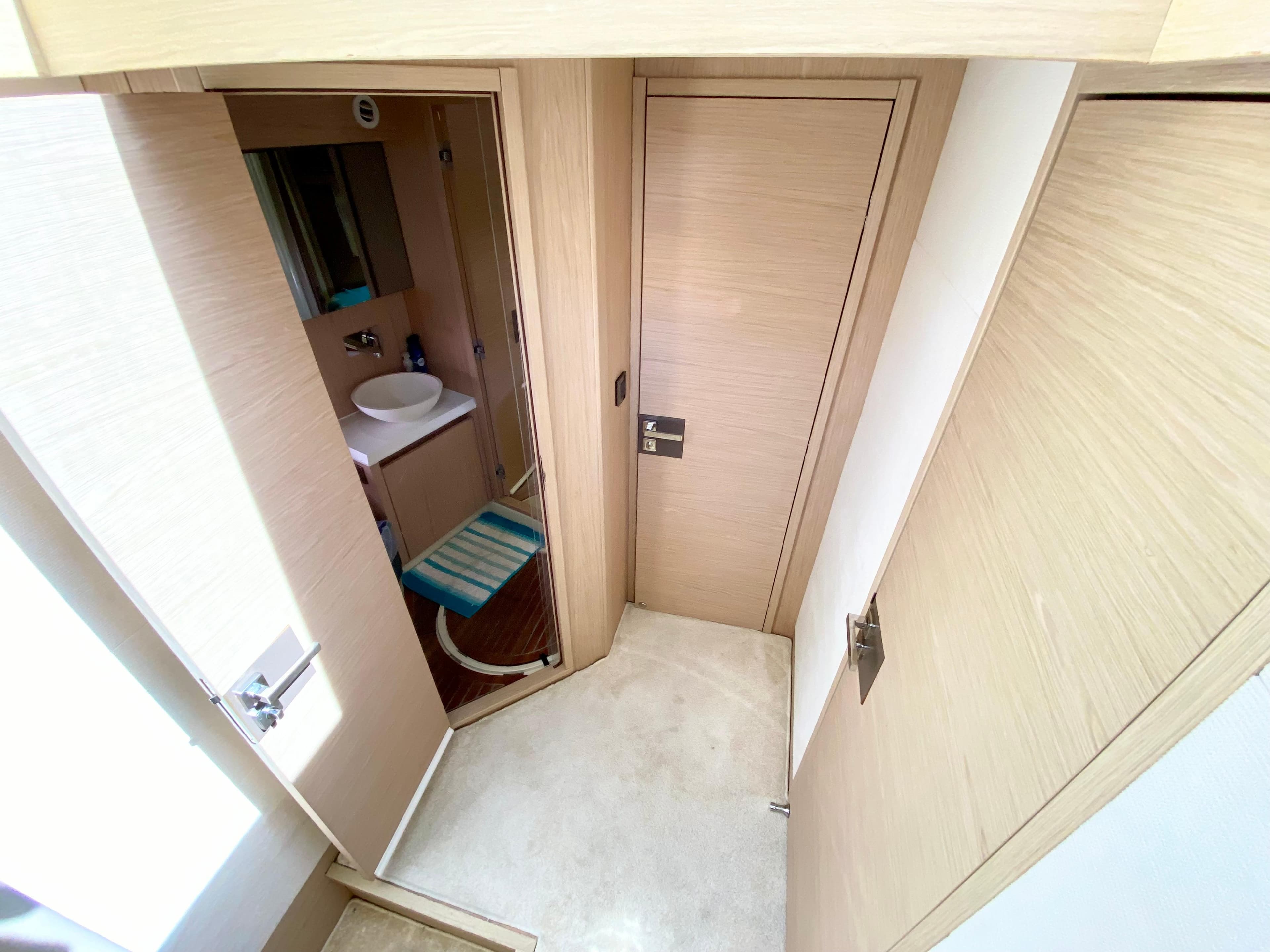 Modern bathroom interior in 2015 Monte Carlo MC5S yacht, featuring sleek design and light wood finishes.