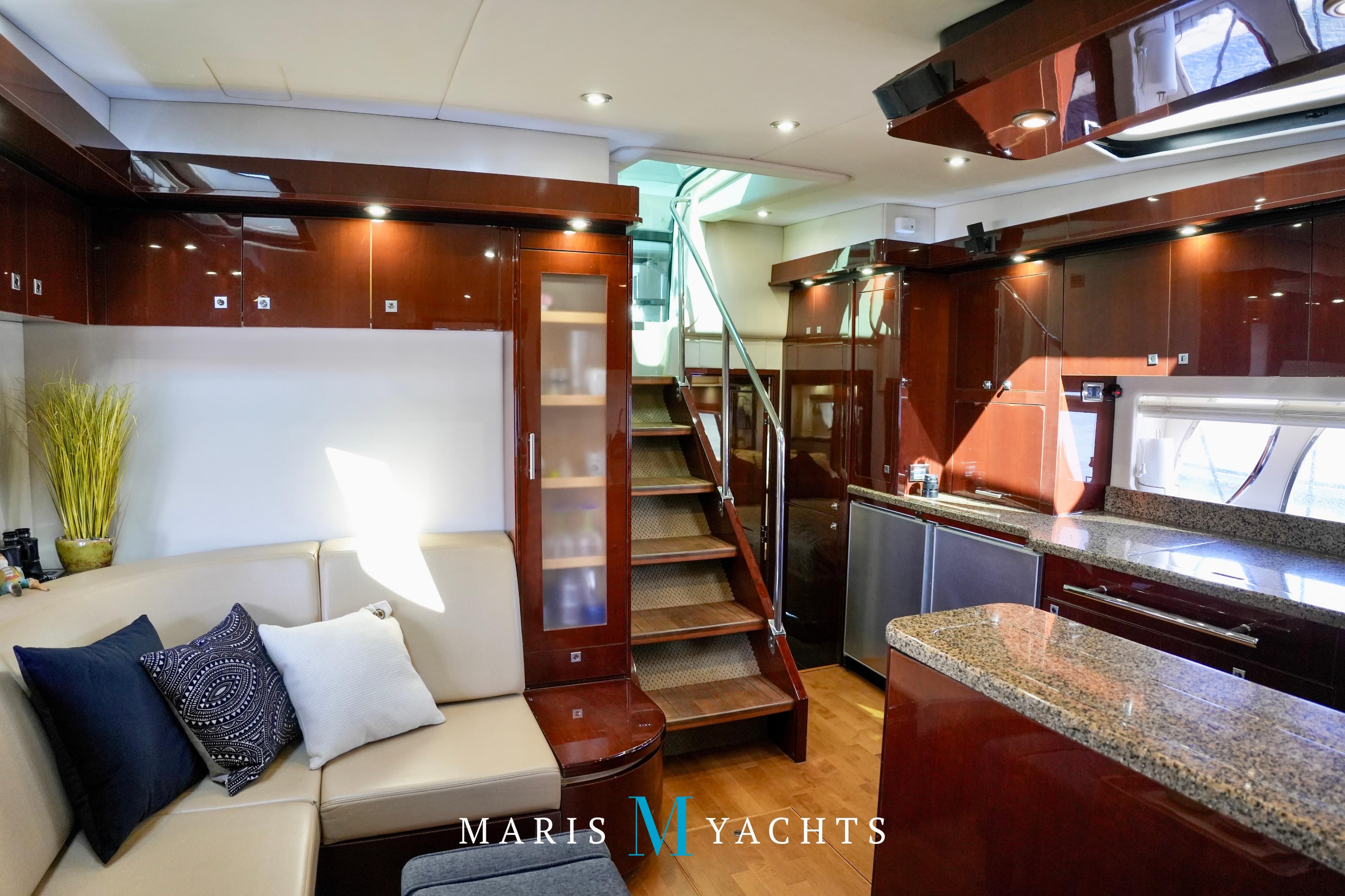 Luxurious interior of 2009 Sea Ray 55 Sundancer yacht with modern kitchen and seating area.