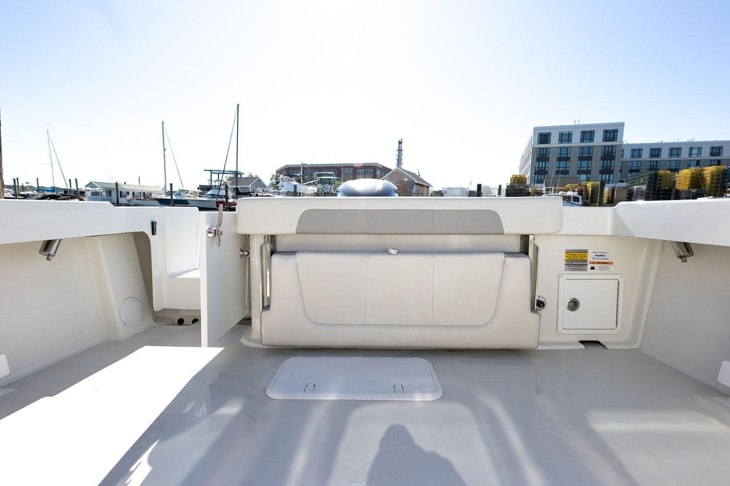 Manufacturer Provided Image: 2026 Parker 257 Explorer boat interior with seating and storage, docked at marina.