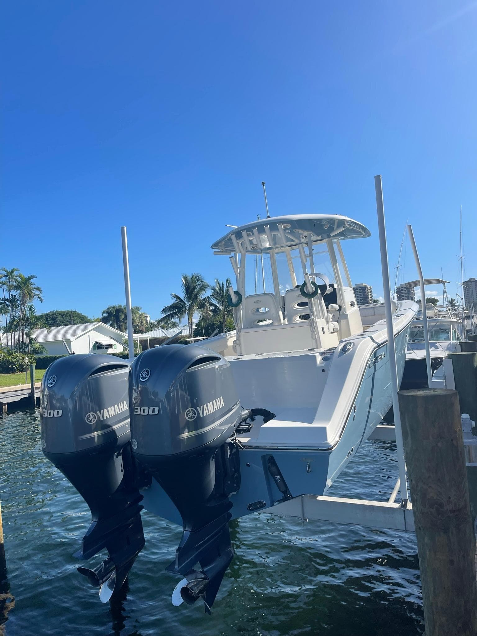 2020 Cobia 301 Center Console boat with Yamaha engines docked.