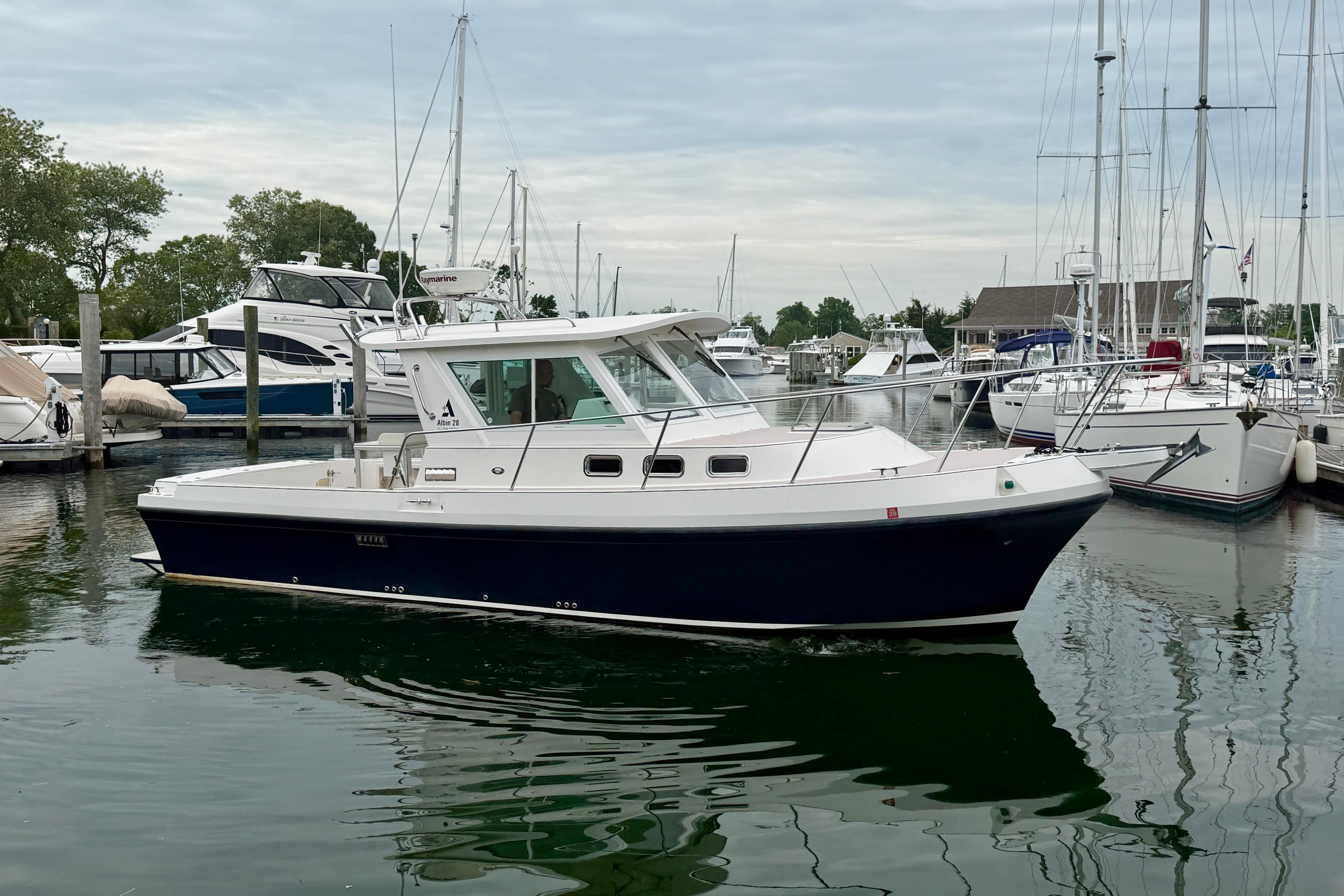 2006 Albin 28 Tournament Express boat docked in a marina with other vessels.