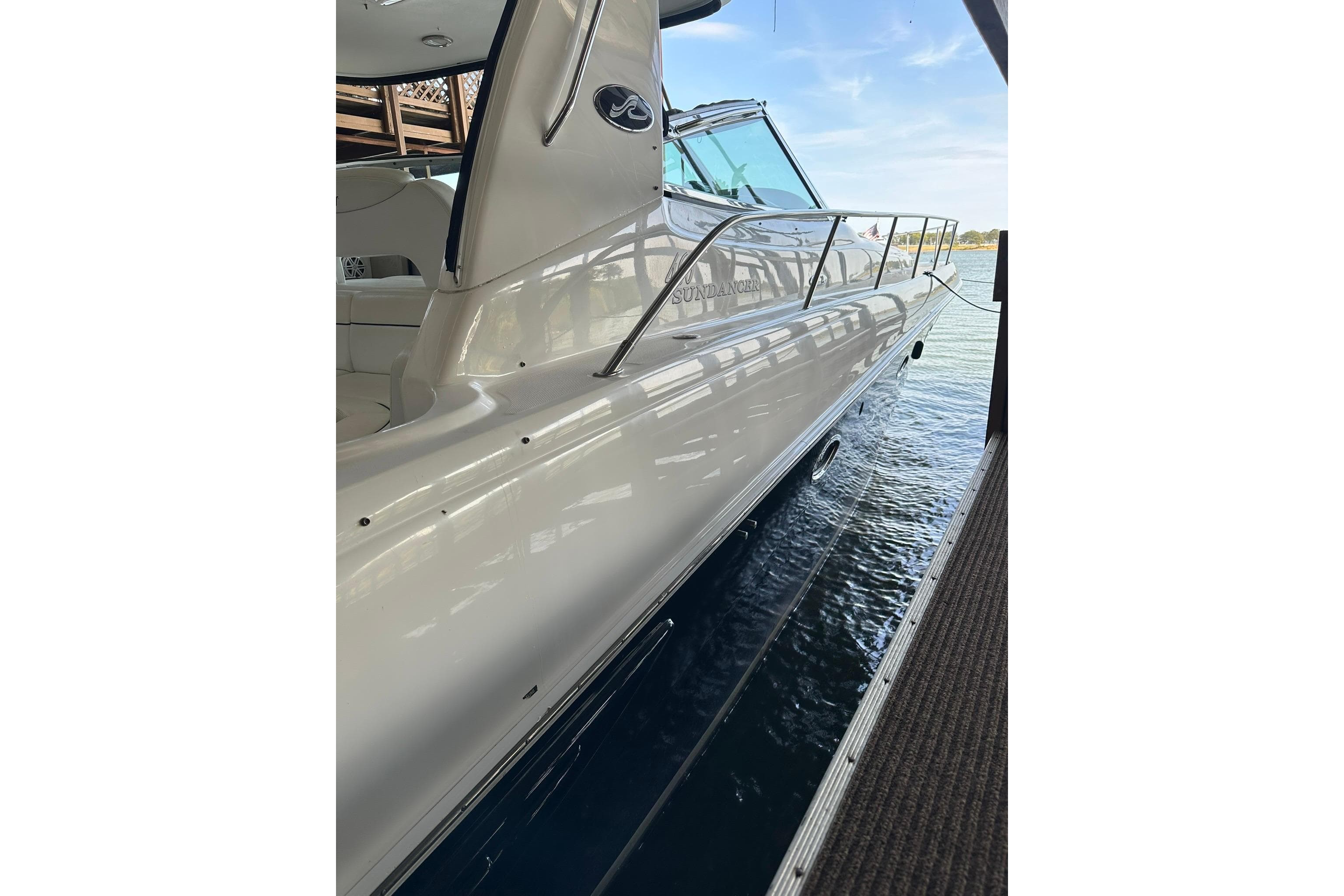2003 Sea Ray 460 Sundancer yacht docked, showcasing sleek design and polished exterior.