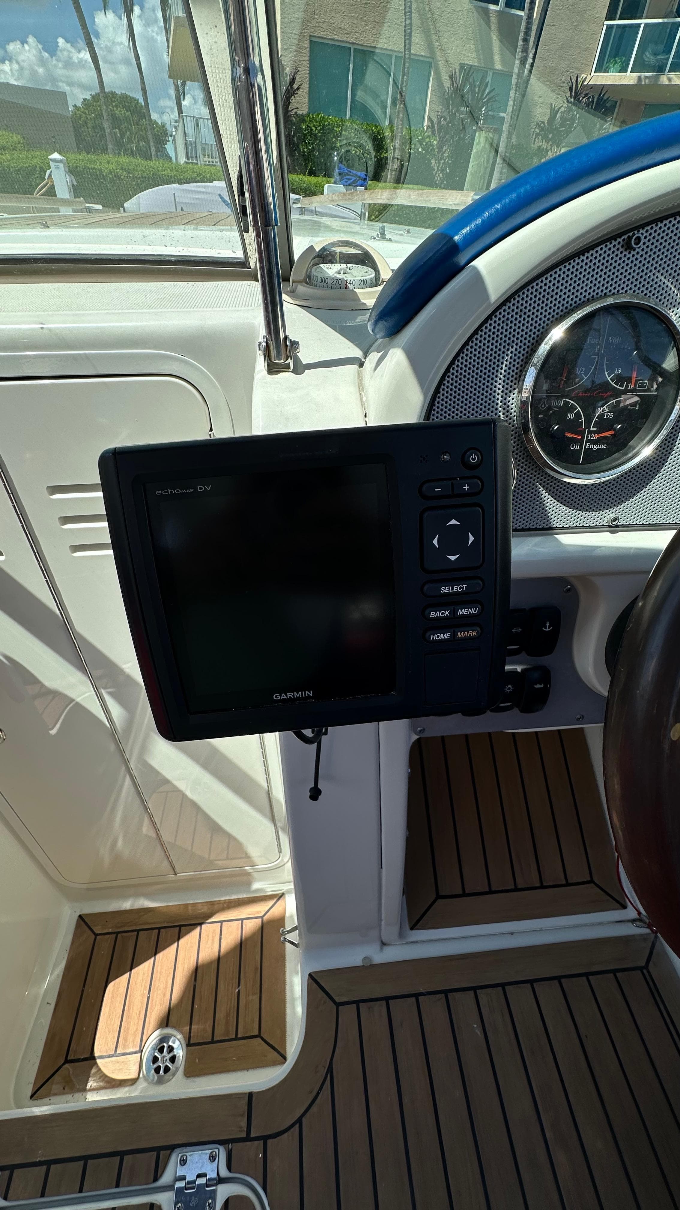 2009 Chris-Craft Corsair 25 dashboard with navigation system and wooden flooring.