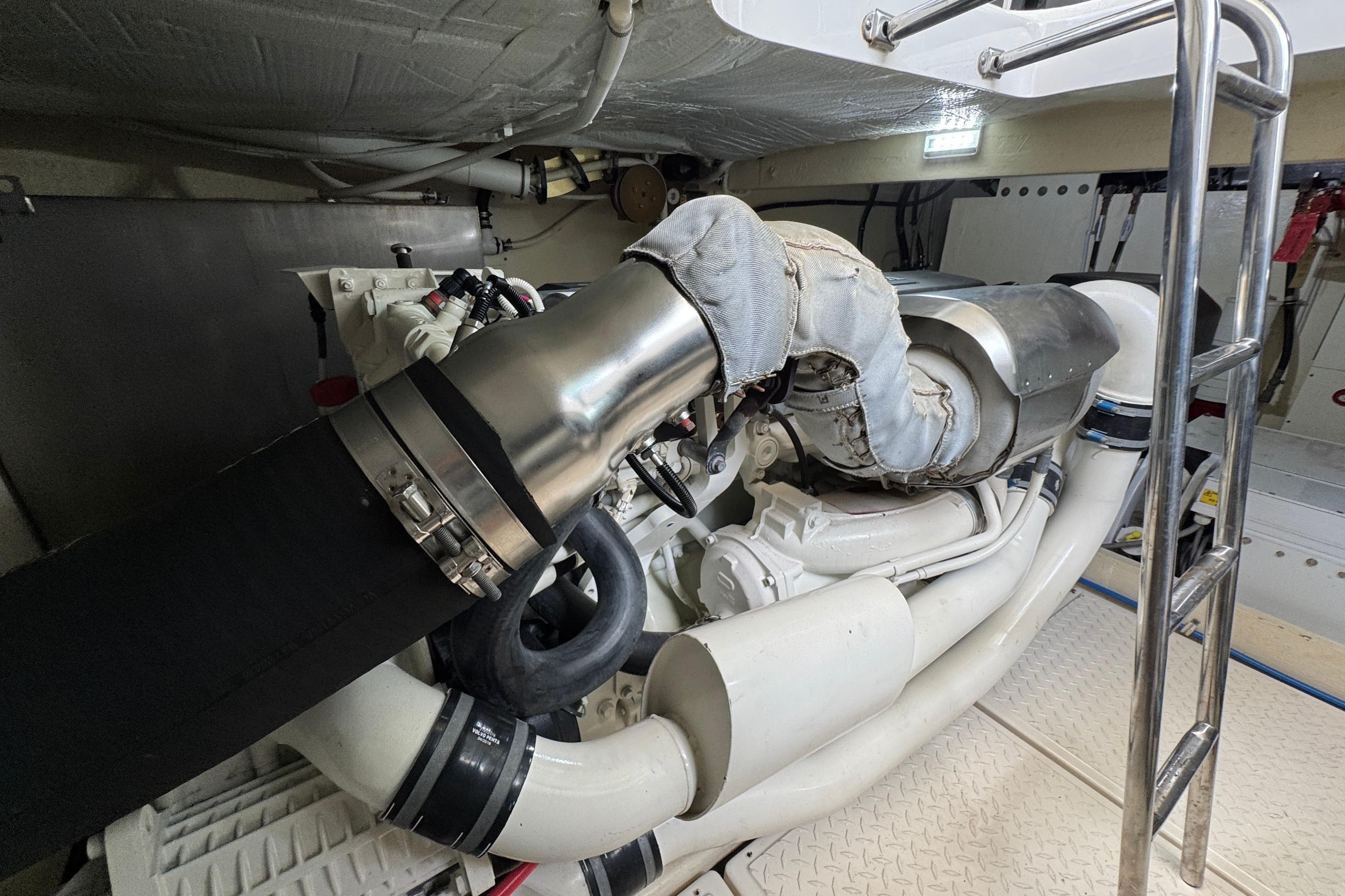 Engine room of 2017 Tiara Yachts F53 Flybridge, showcasing detailed mechanical components.