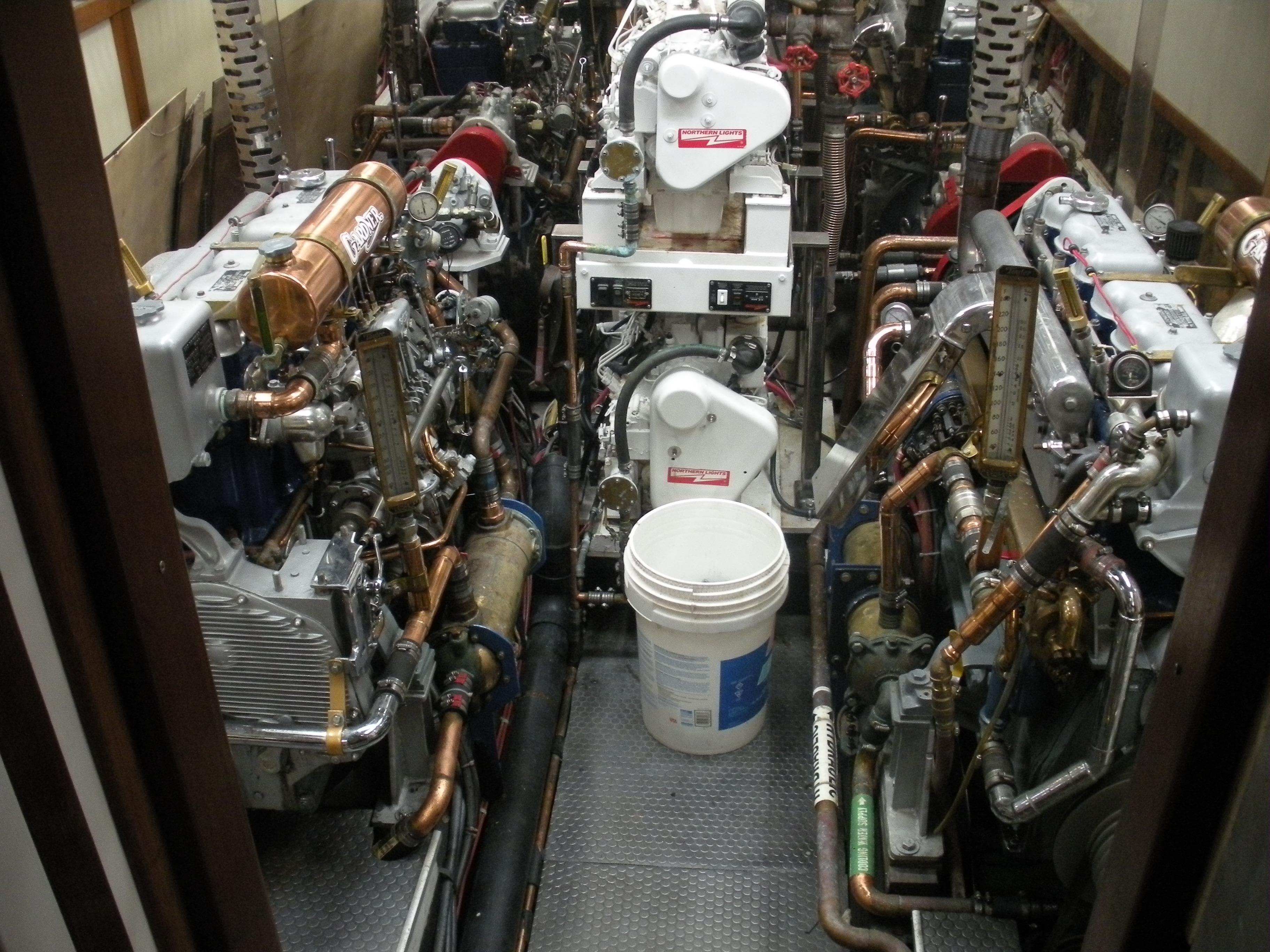 Engine room of a 1929 Custom HOFFAR-BEECHING Fantail Yacht with complex machinery.