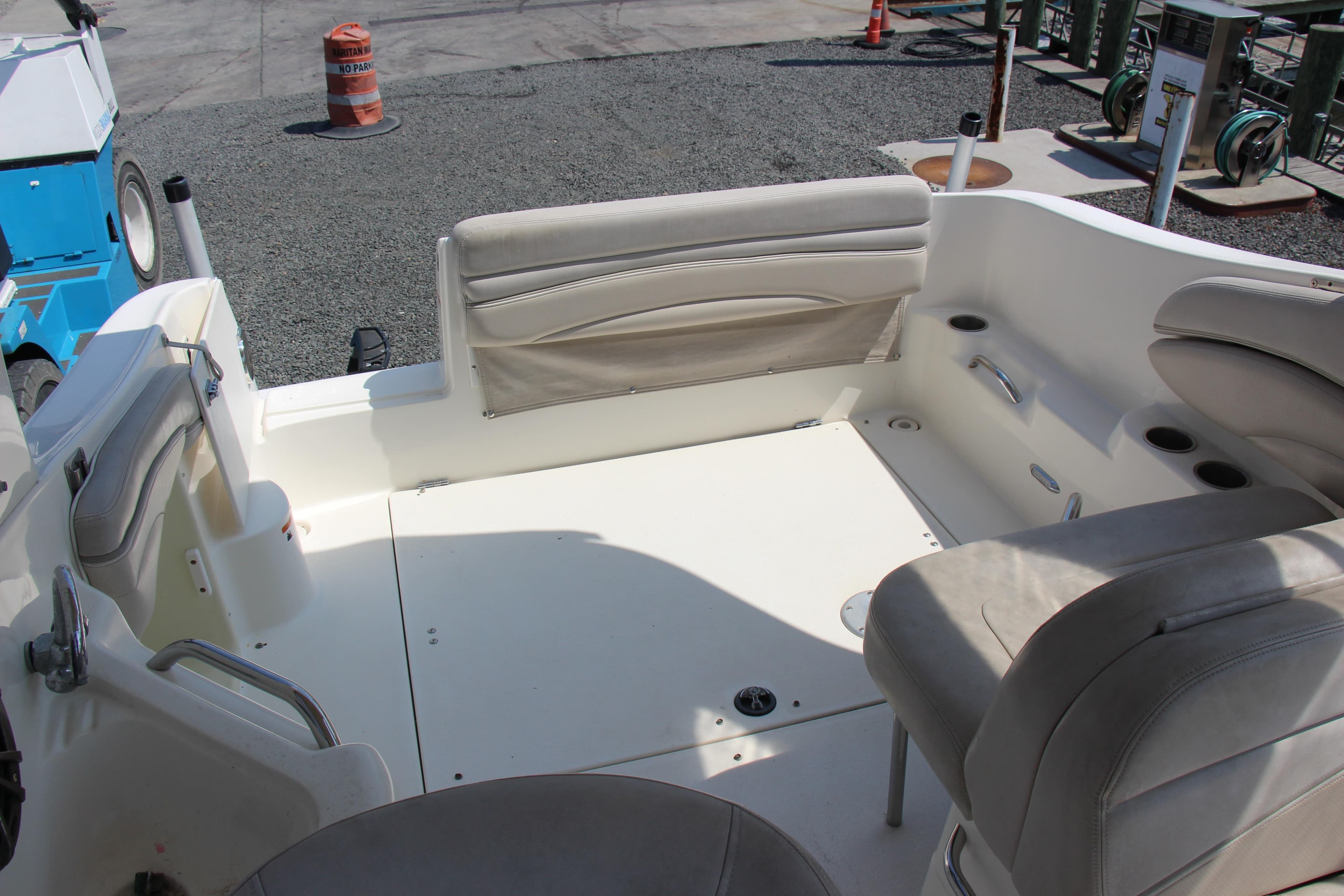 2008 Larson Cabrio 260 boat interior with beige seating and cup holders.
