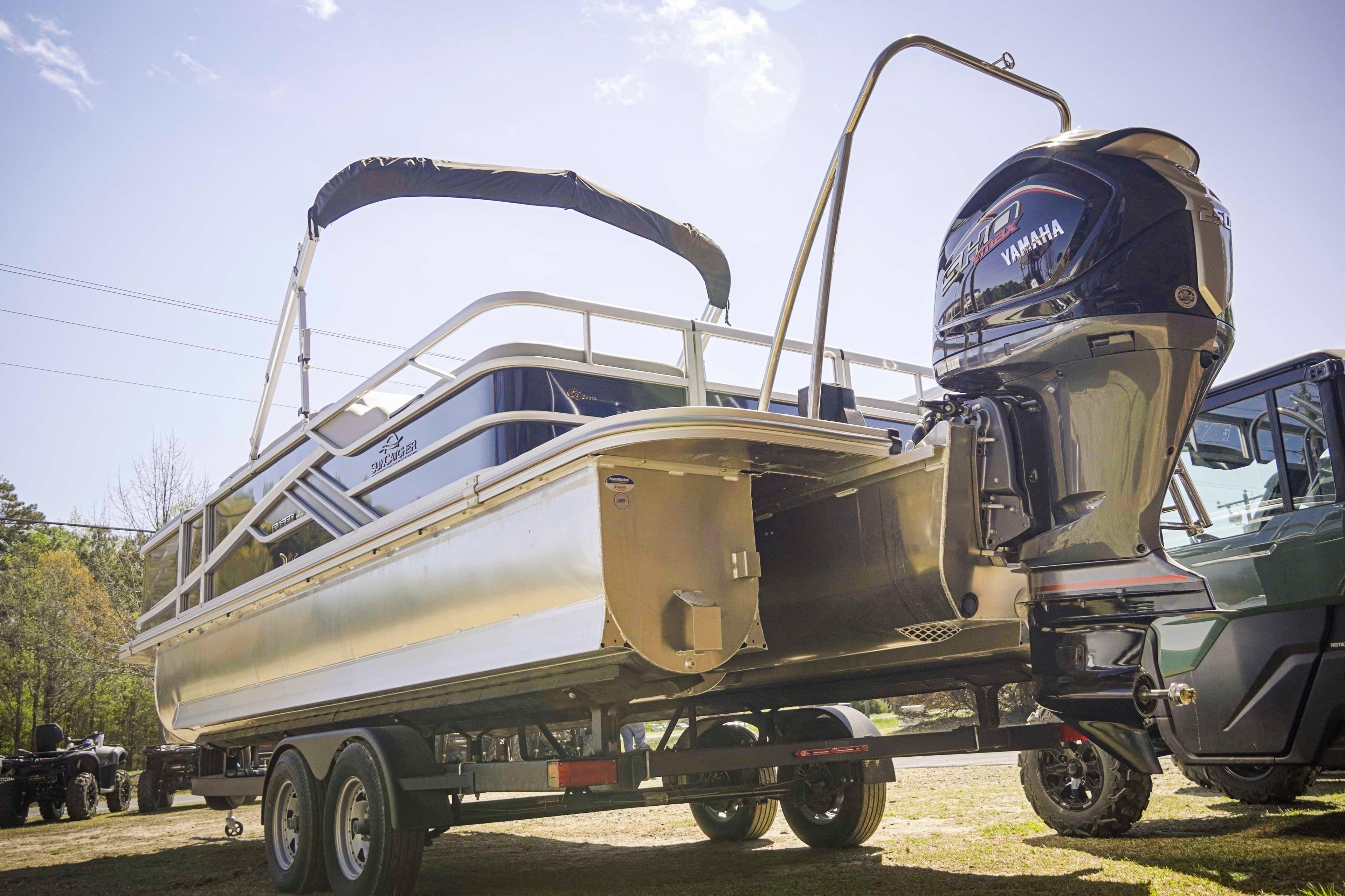 2025 SunCatcher Fusion 324SS pontoon boat on trailer with Yamaha outboard motor.