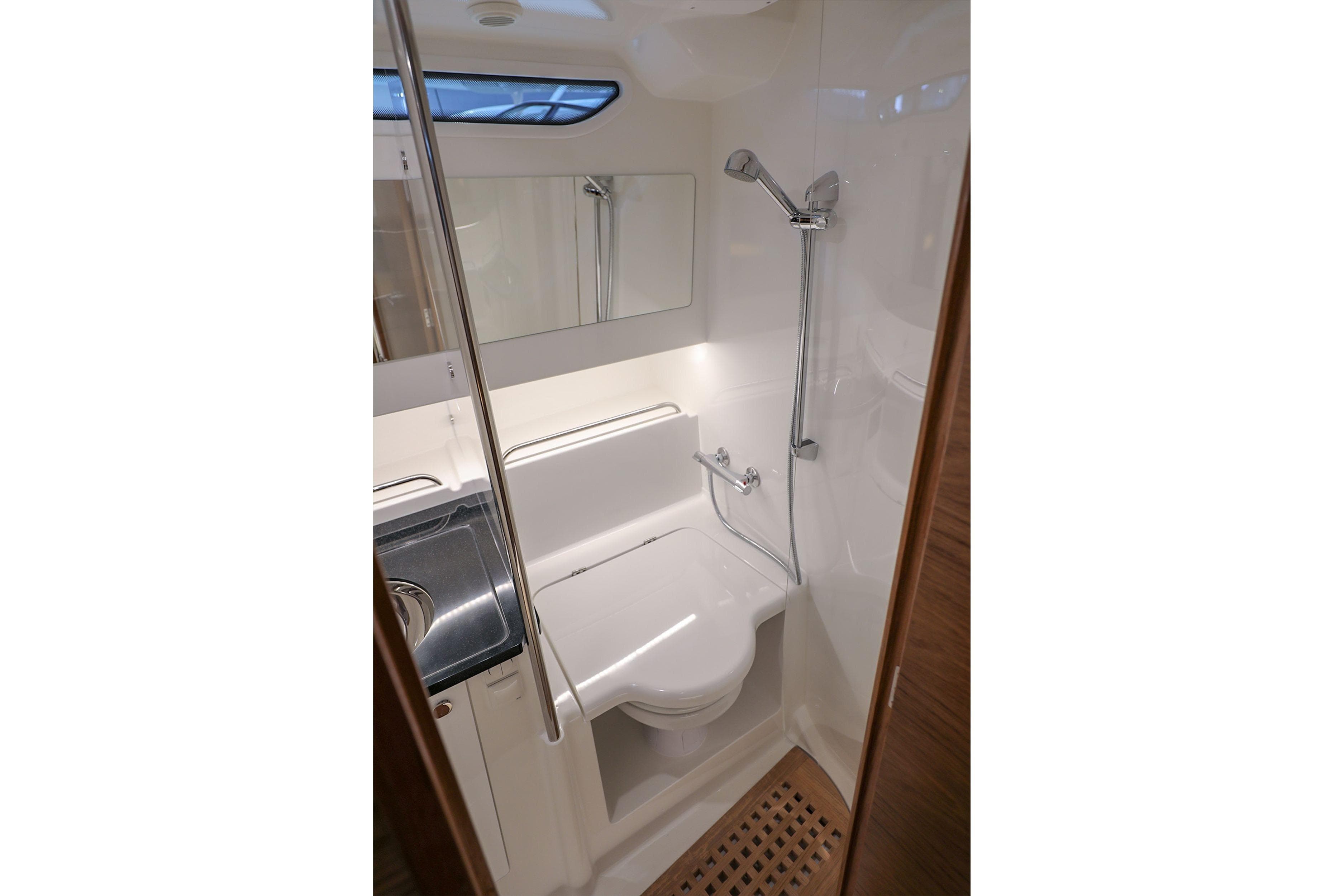 Modern bathroom interior in 2025 Nimbus T11 boat, featuring shower and sink.
