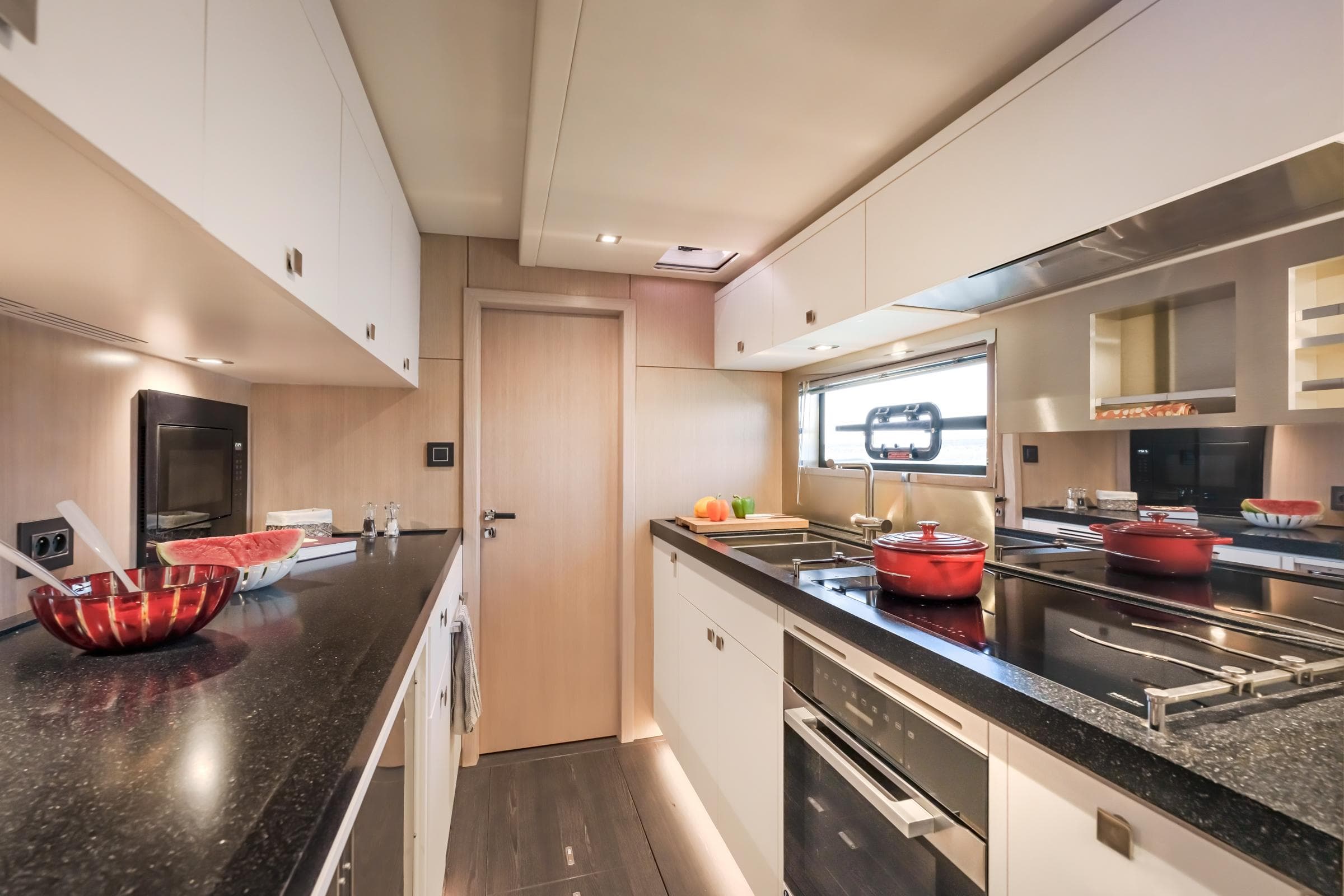 Modern kitchen interior in 2025 Privilege Signature 650 yacht, featuring sleek countertops and appliances.