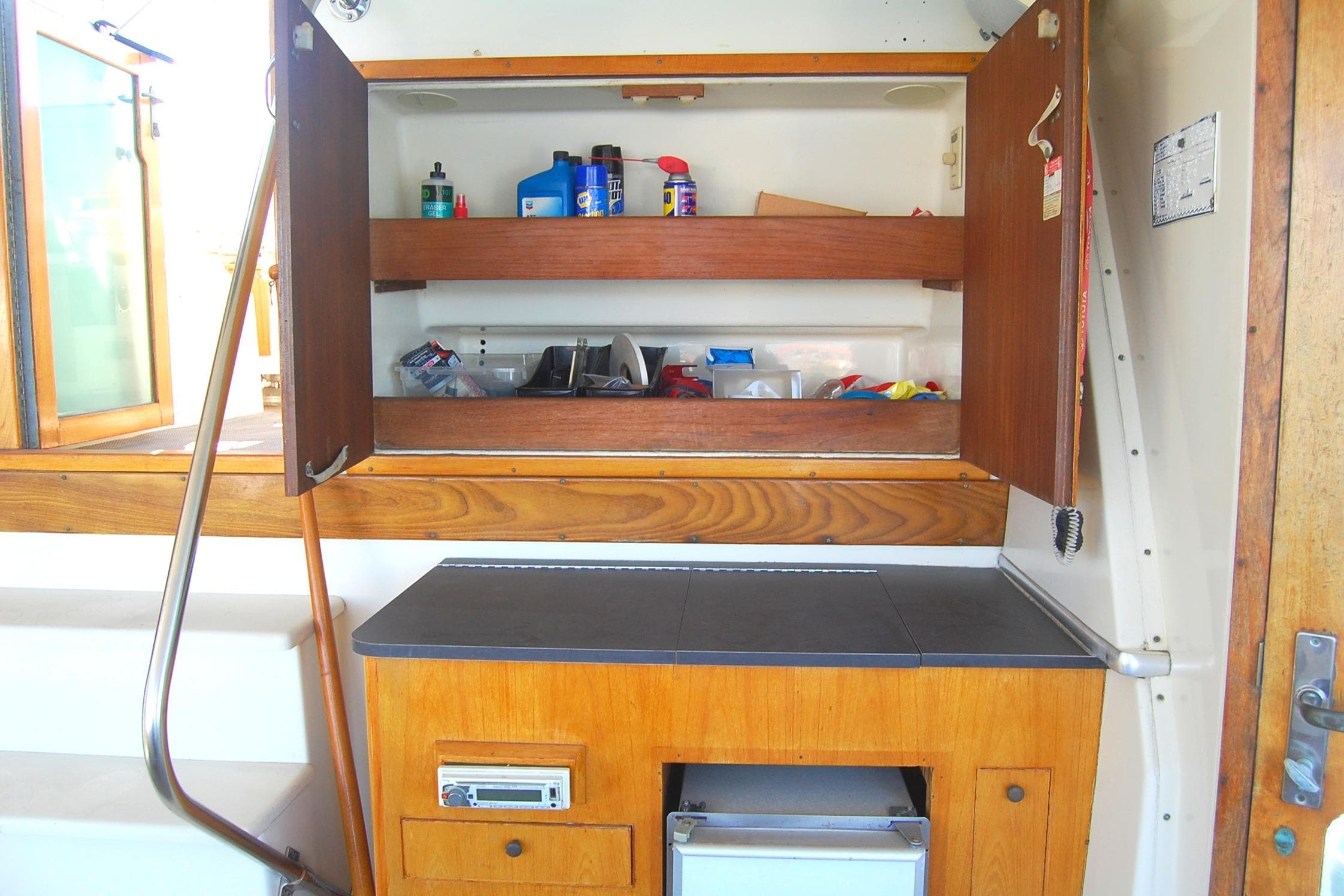 1981 Hatteras 48 Cockpit MY interior with wooden cabinets and storage shelves.