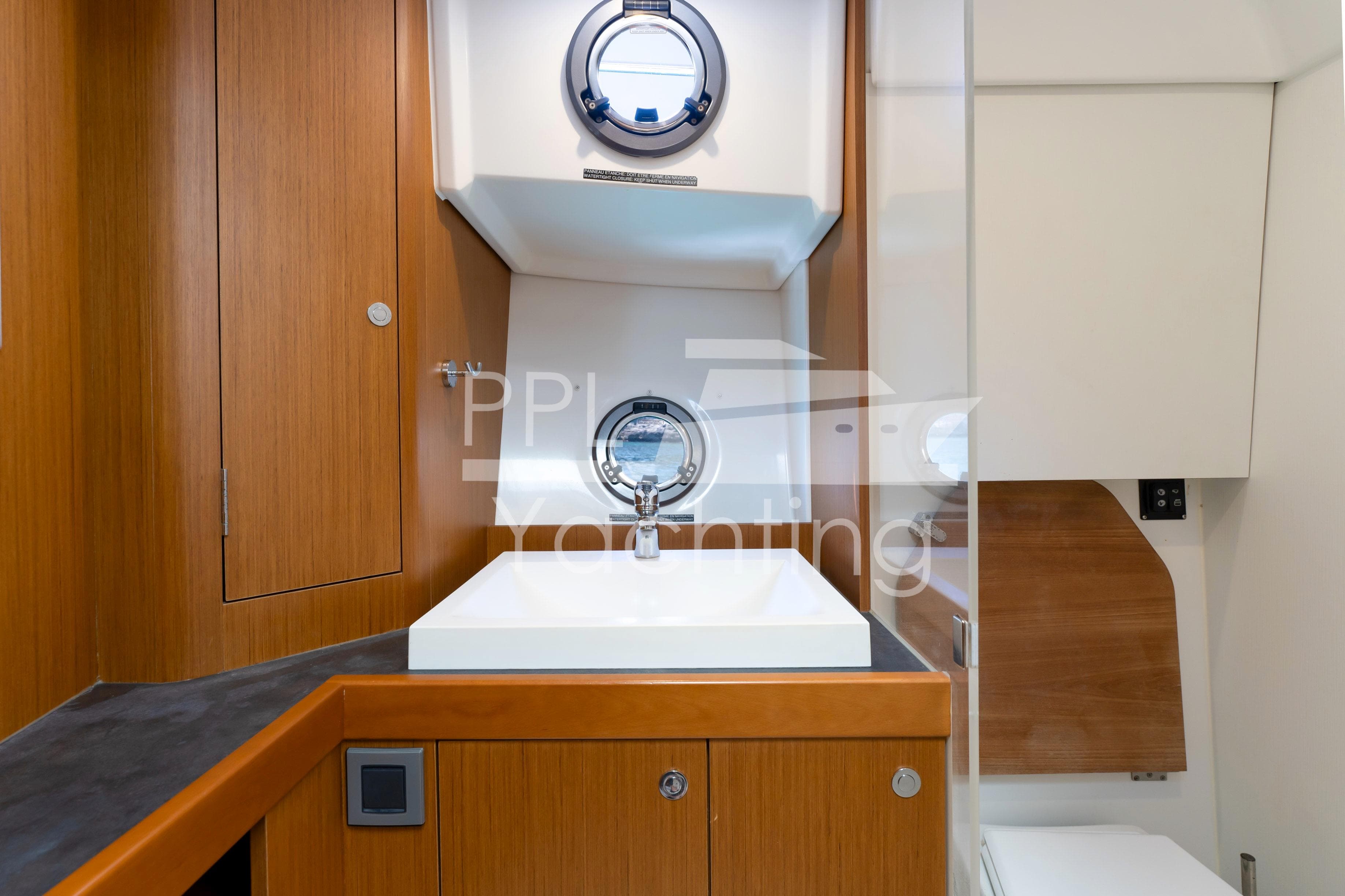 2019 Beneteau Swift Trawler 35 bathroom with wooden cabinetry and modern sink.