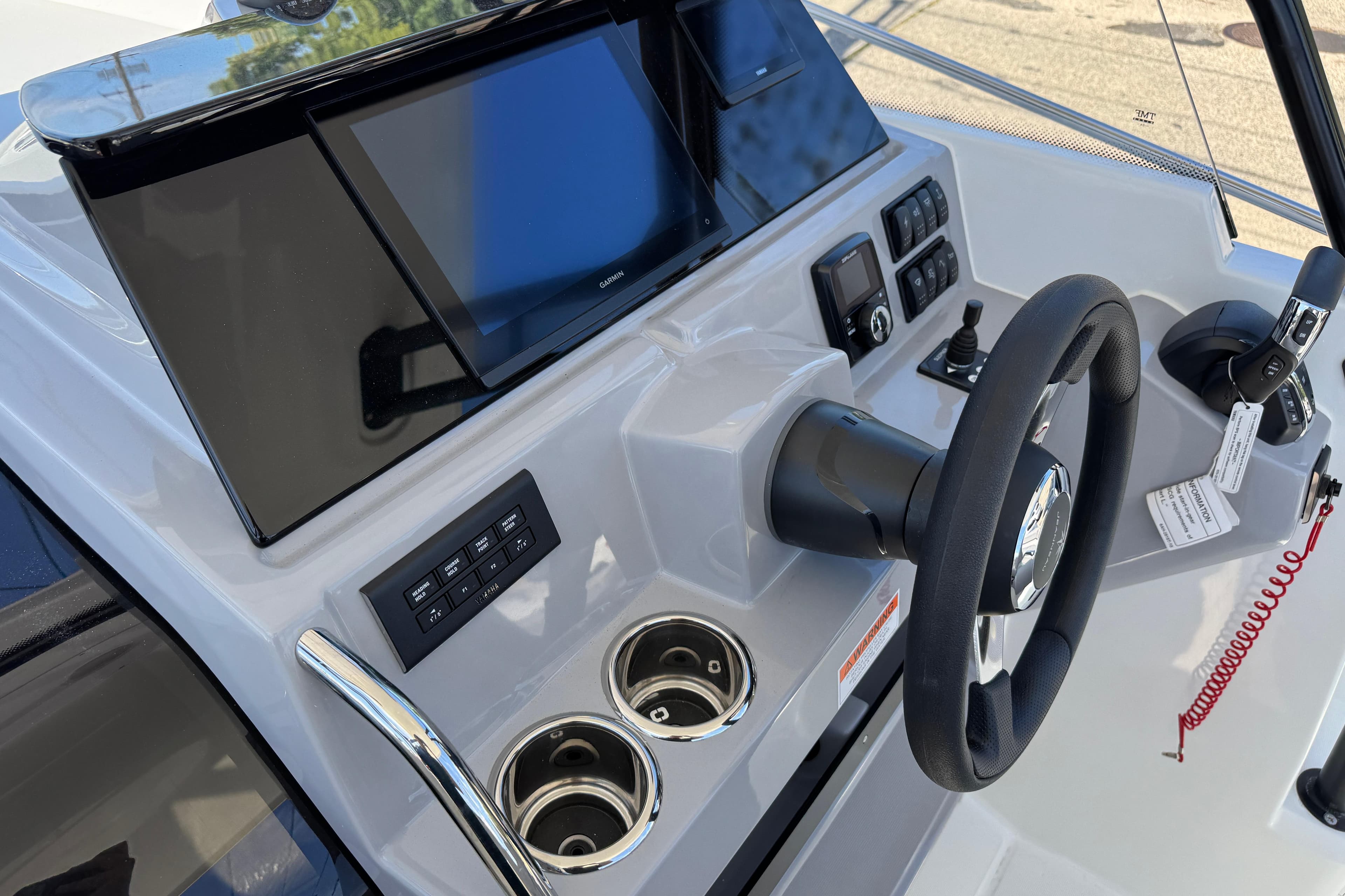 2026 Jeanneau Leader WA 7.5 boat dashboard with steering wheel and control panel.