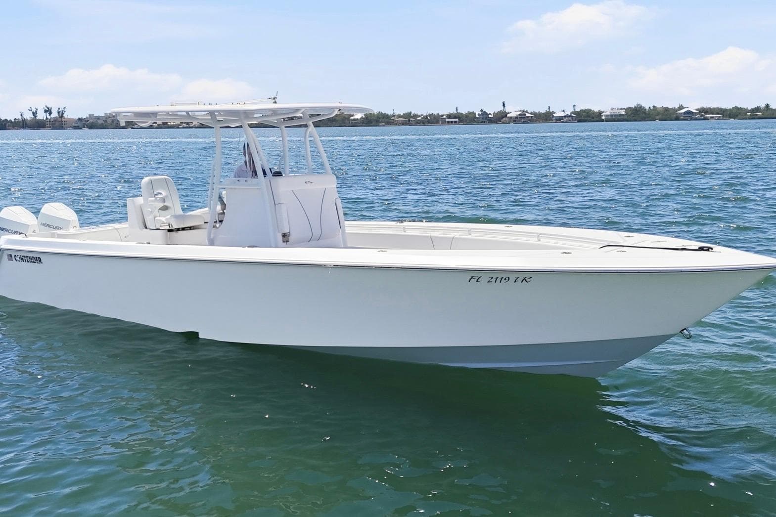 2024 Contender 32 ST boat on calm water, showcasing sleek design and modern features.