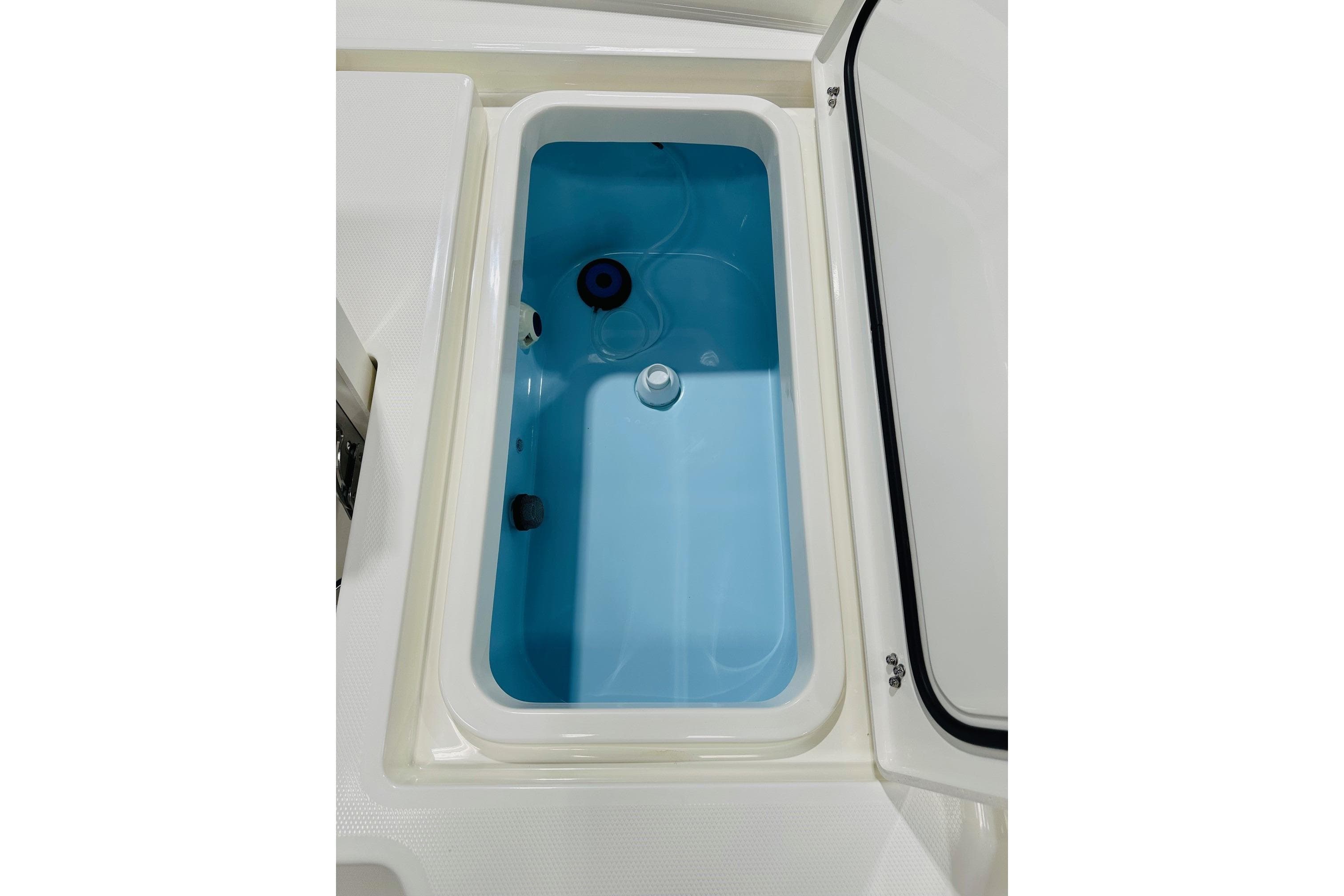 Livewell compartment in 2026 Pathfinder 2600 TRS boat, featuring a blue interior.