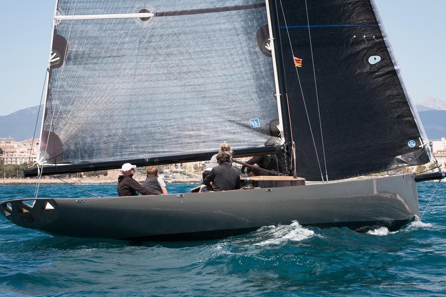 Sailing yacht Wallynano 37, 2009 model, gliding on blue waters with crew onboard.