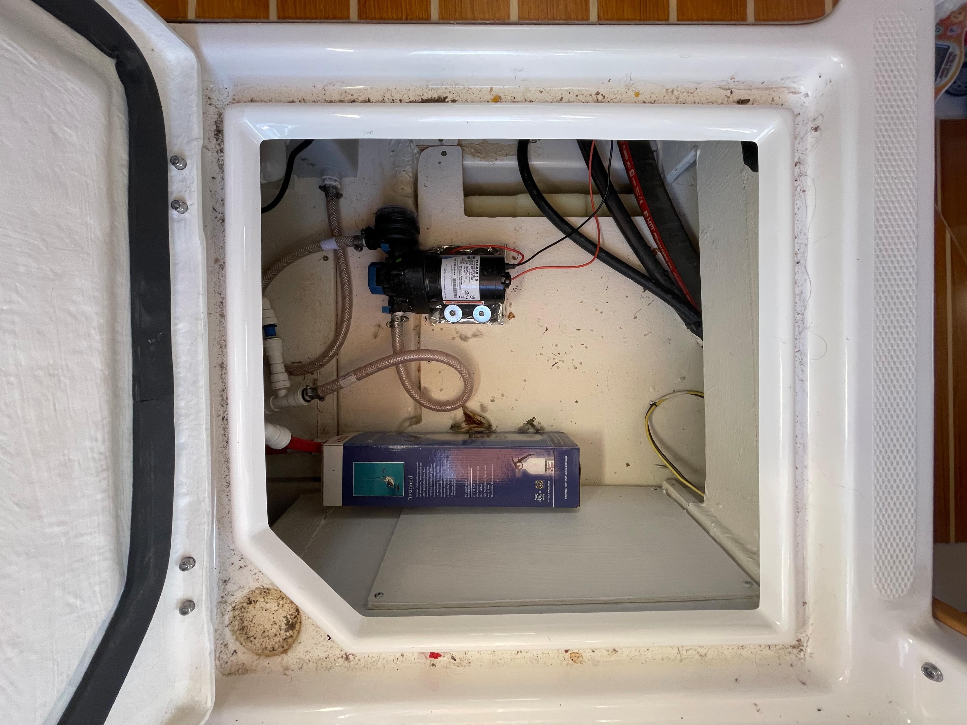 2022 Cutwater Flybridge compartment with pump and wiring.