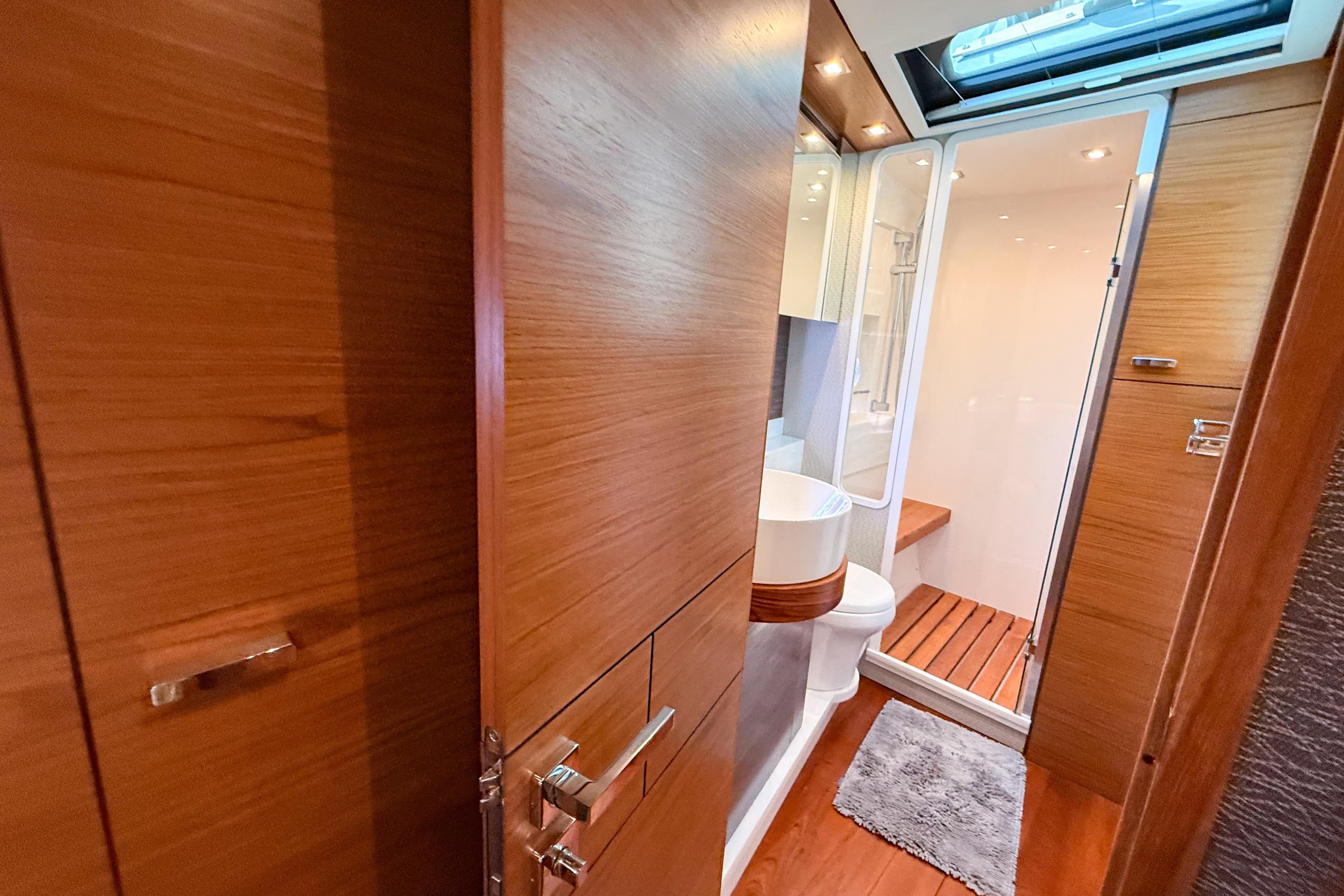Luxurious bathroom interior of 2019 Tiara Yachts F53 Flybridge with wood accents and modern fixtures.