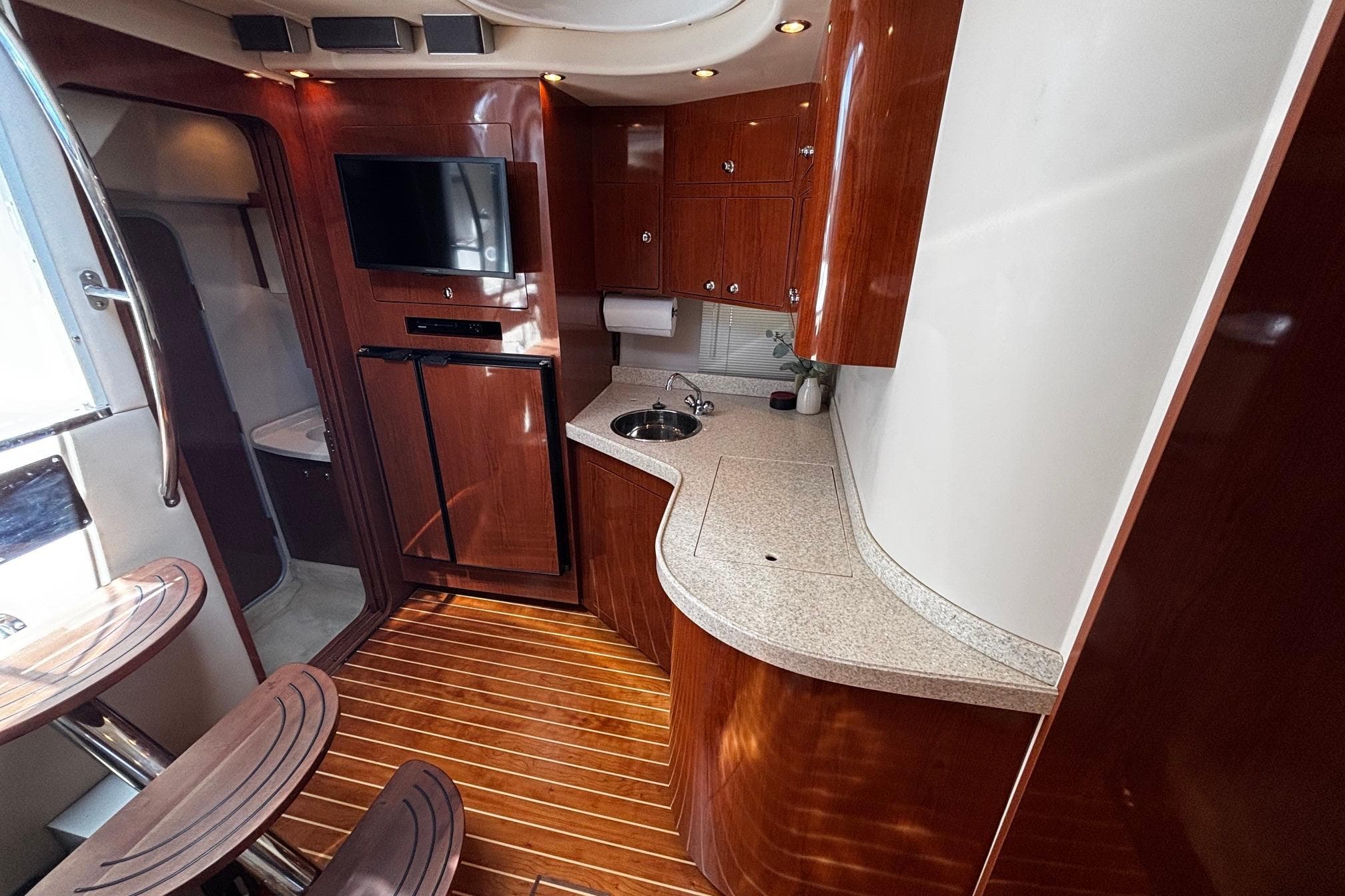 Luxurious 2006 Regal Commodore 3860 yacht interior with elegant wood finishes and modern amenities.