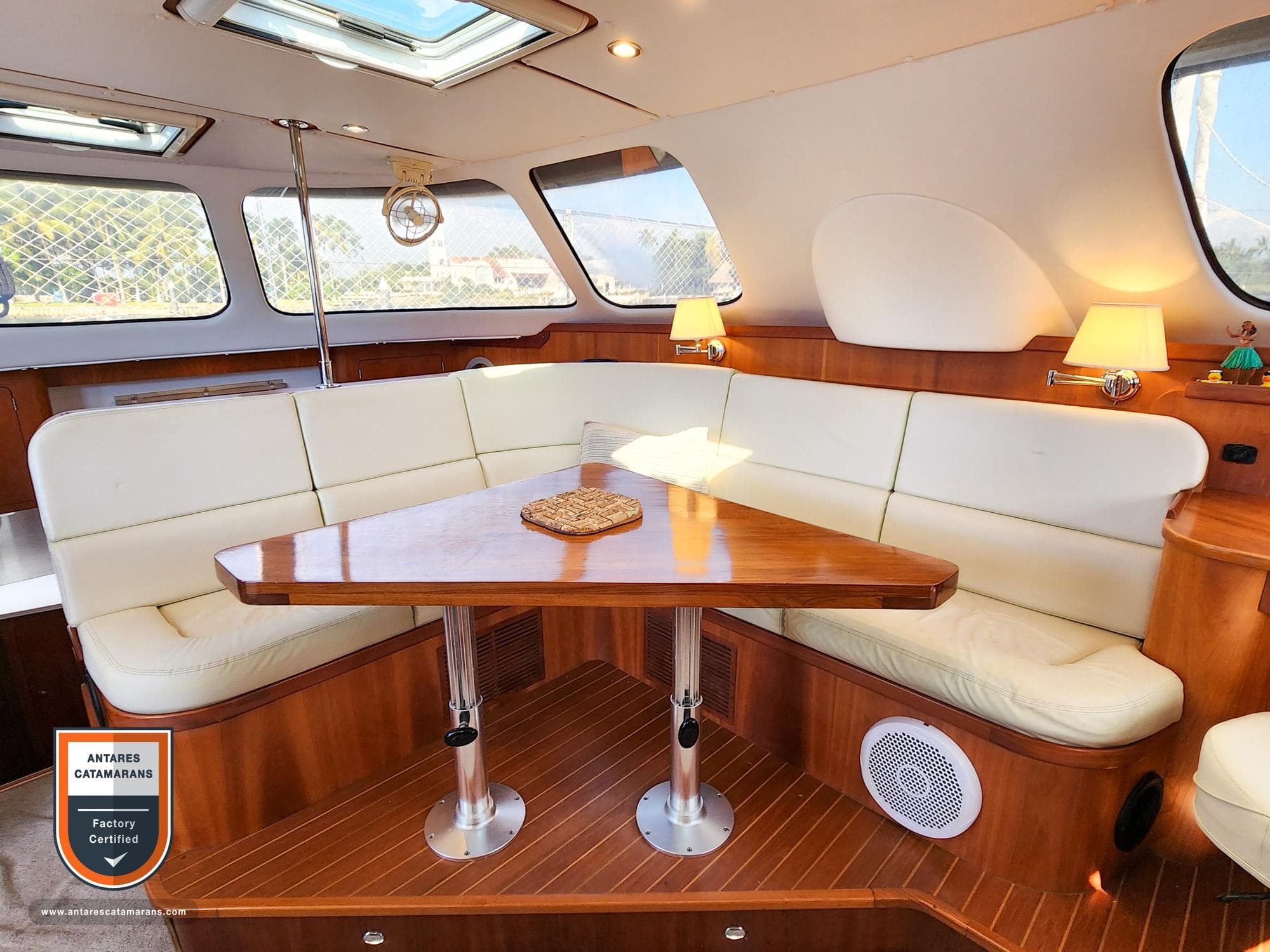 Luxurious interior of 2019 Antares 44 GT catamaran with elegant seating and wooden table.