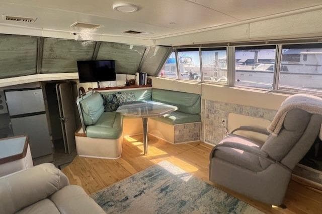 Interior of 1989 Trojan 12 Meter Motor Yacht with seating, table, and windows.