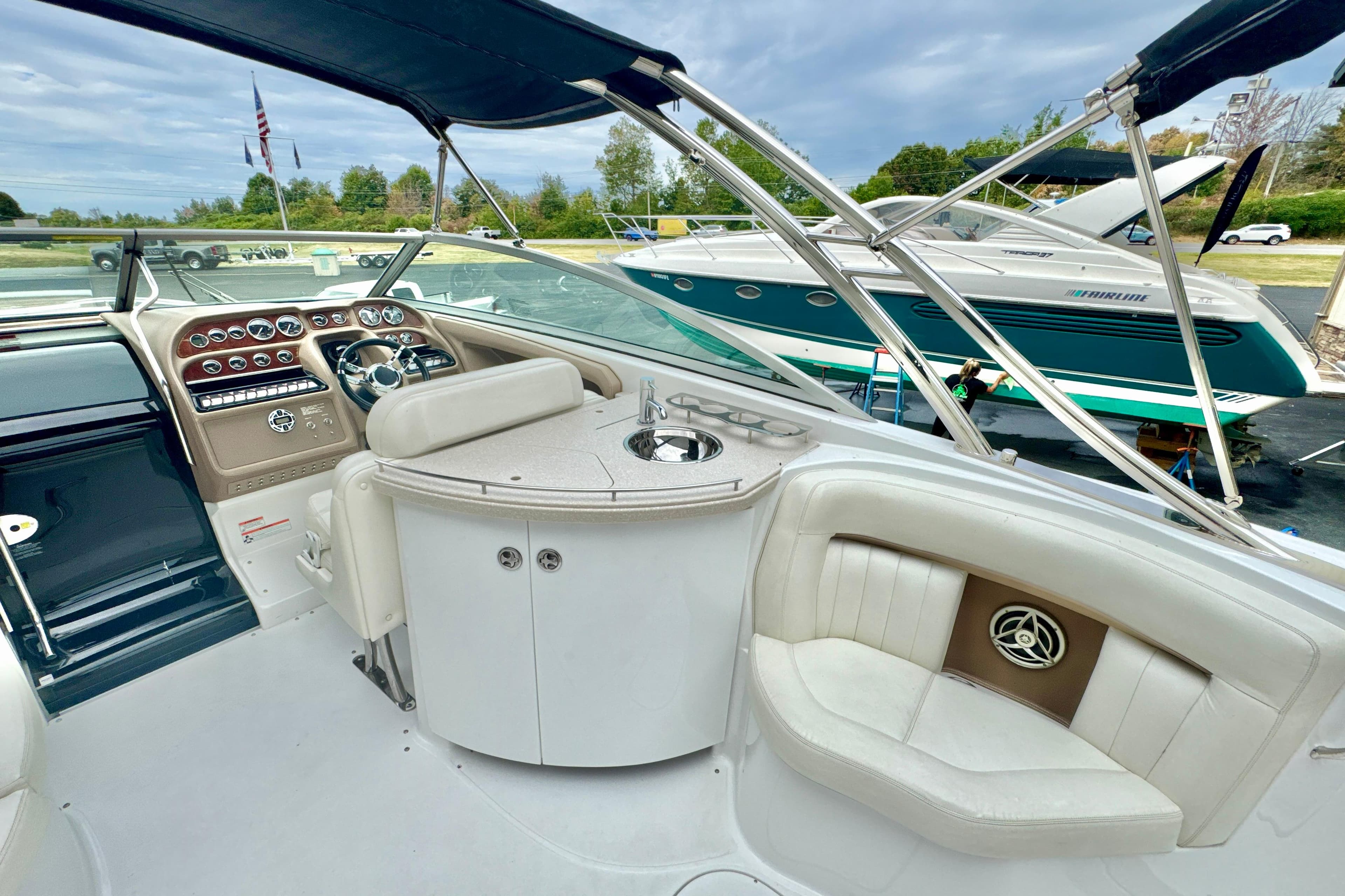 Interior of a 2008 Cobalt 323 boat with luxurious seating and control panel.