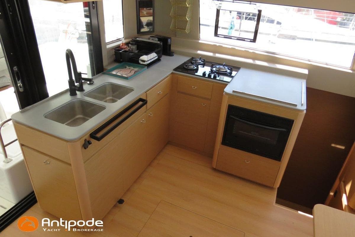 Modern yacht kitchen with dual sinks, stove, and oven in 2023 Excess 14 model.