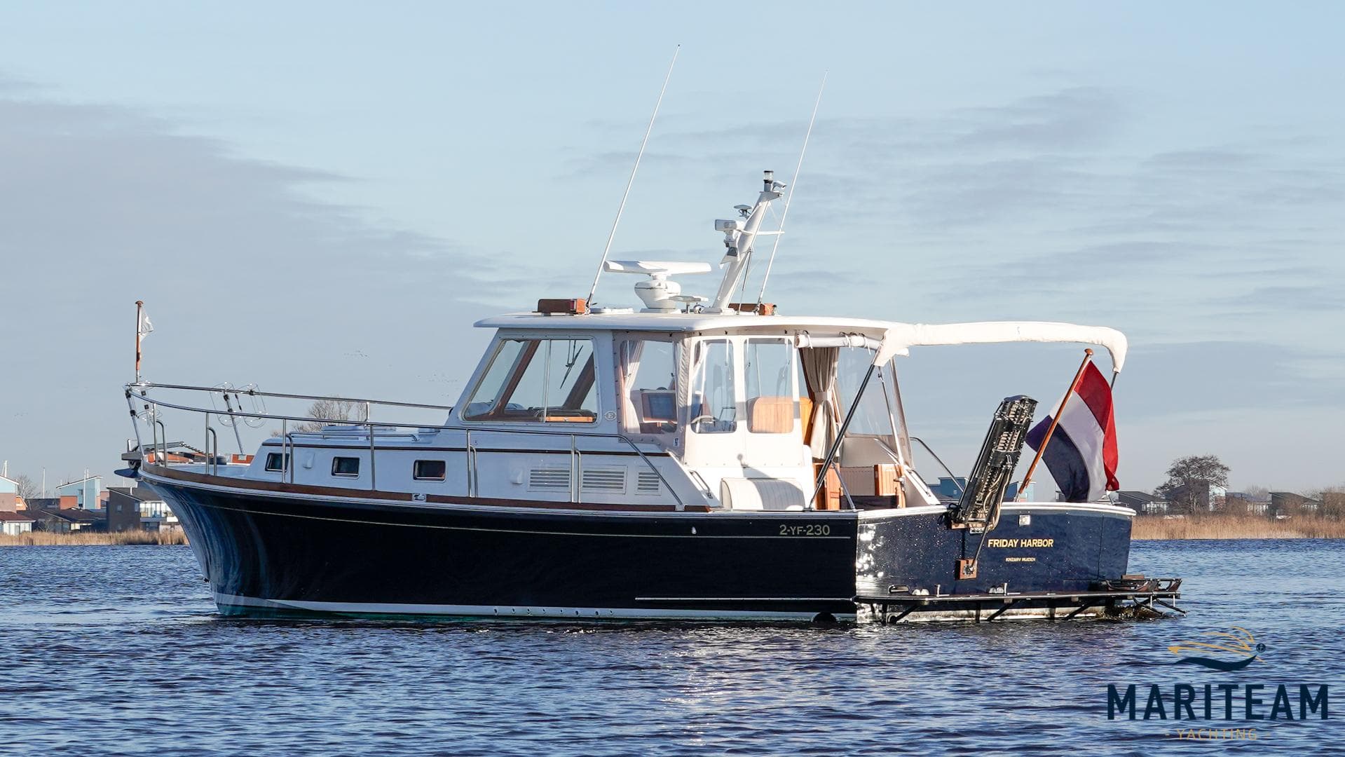 Grand Banks Eastbay 38 HX 2000 yacht on calm water, side view.