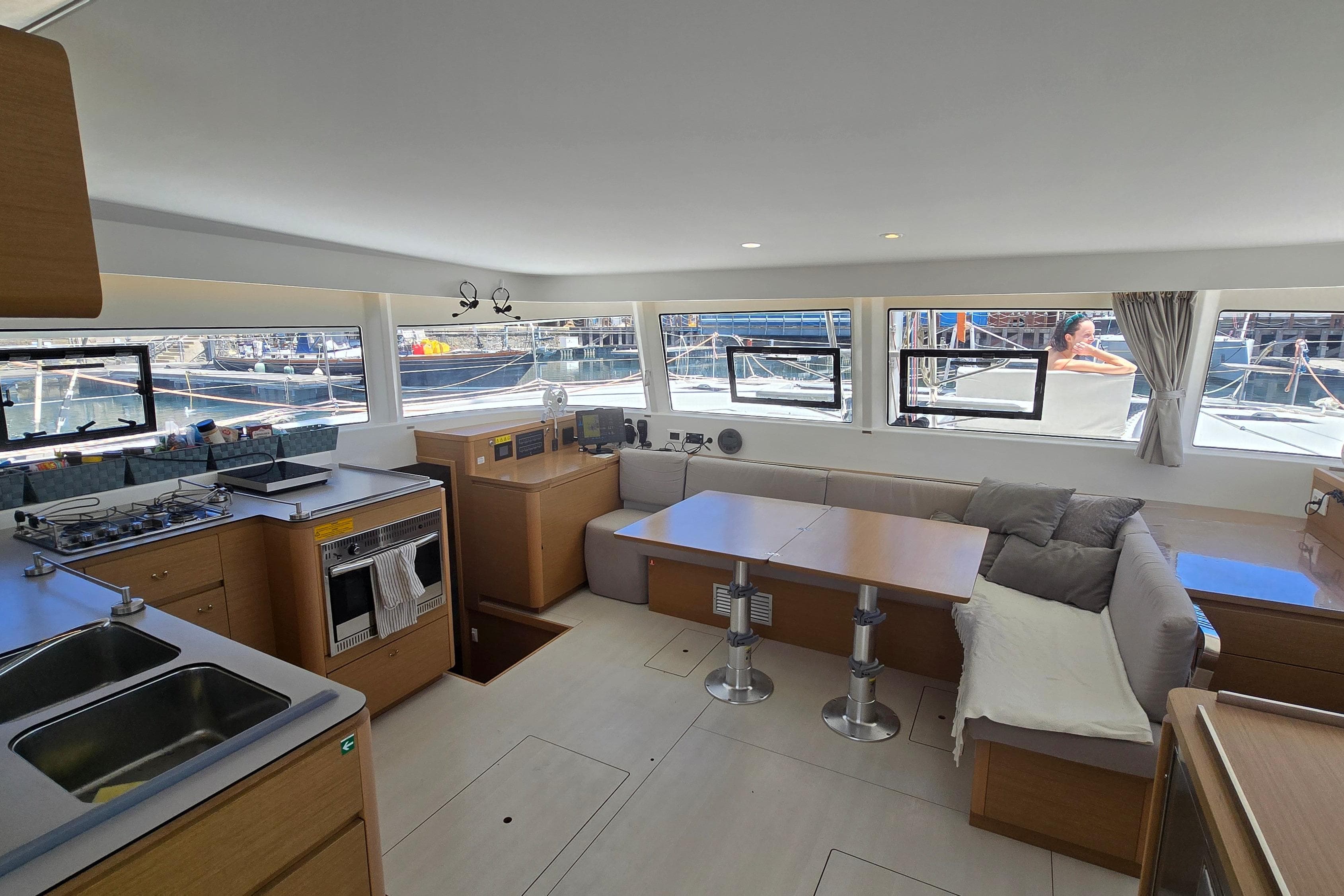 Interior of 2024 Excess 14 catamaran with modern kitchen and spacious seating area.