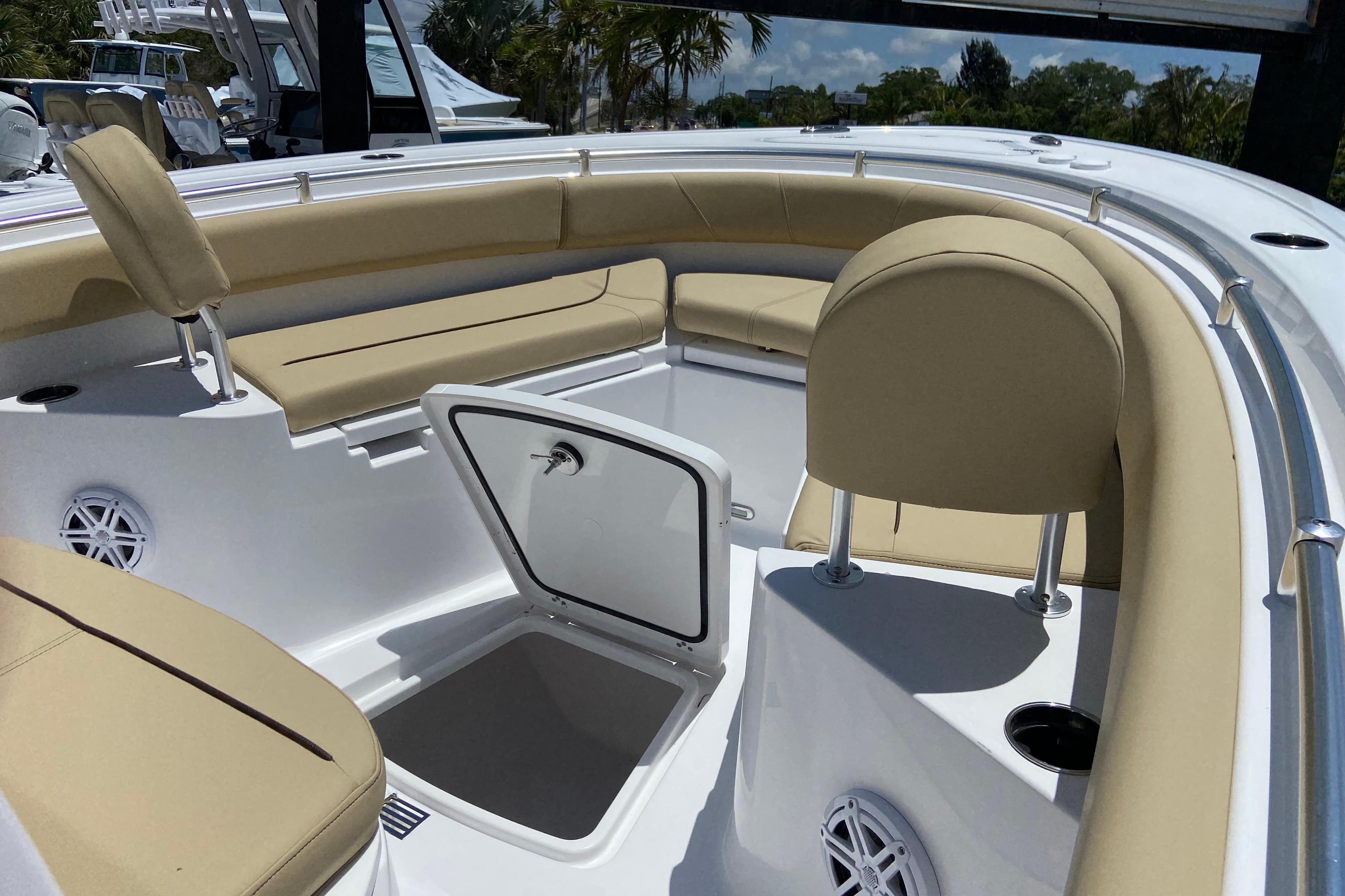 2026 Sportsman Heritage 231 Center Console boat interior with beige seating and storage compartment.