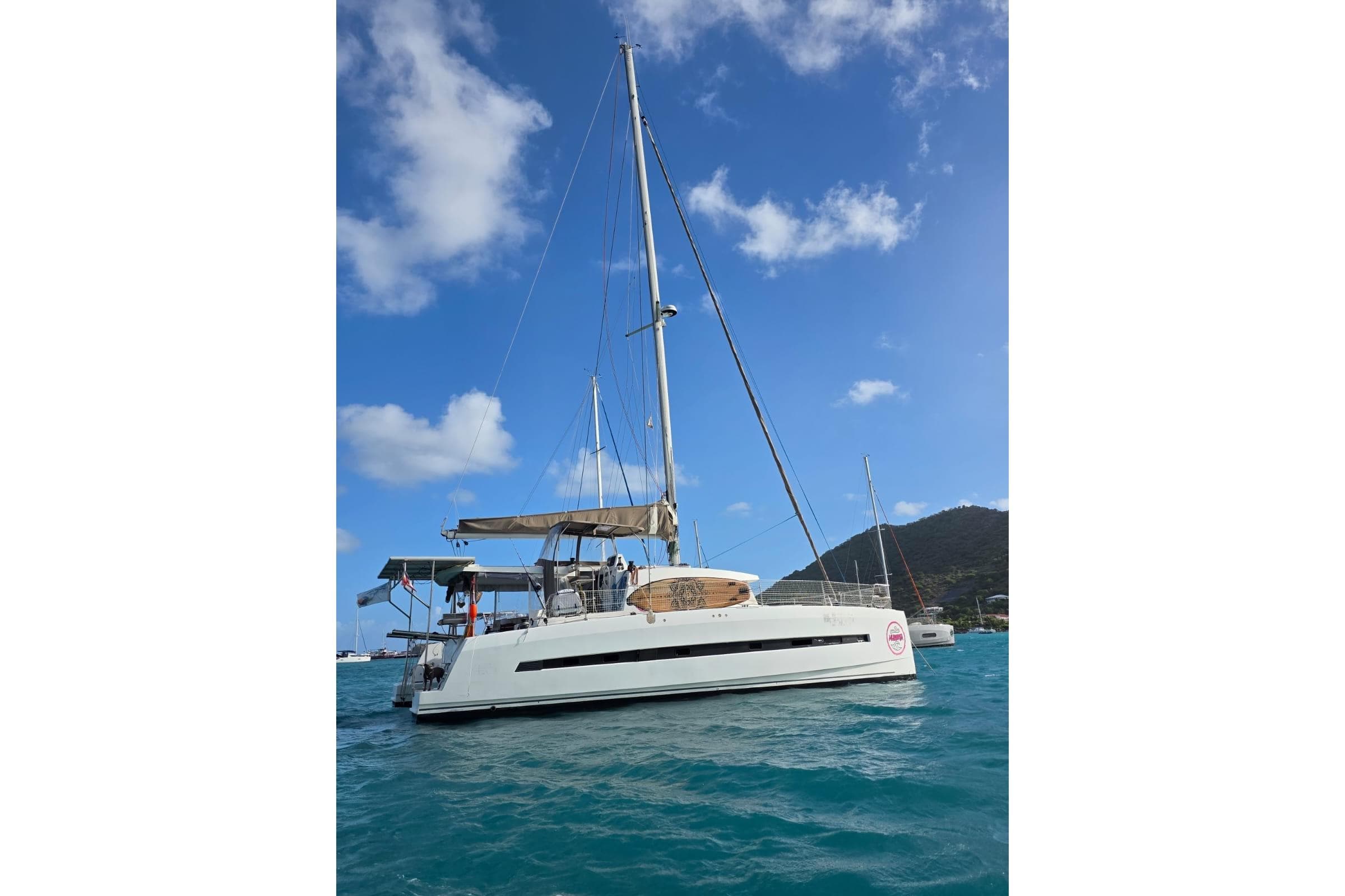 Sailing catamaran Bali 4.5, 2016 model, anchored in turquoise waters under a clear blue sky.
