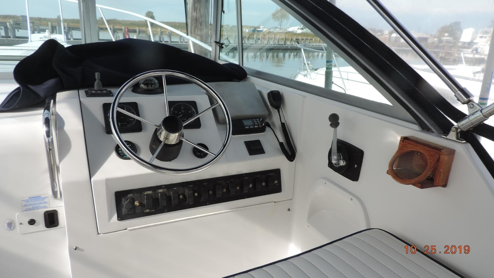 1998 Mainship 30 PILOT boat helm with steering wheel and control panel.