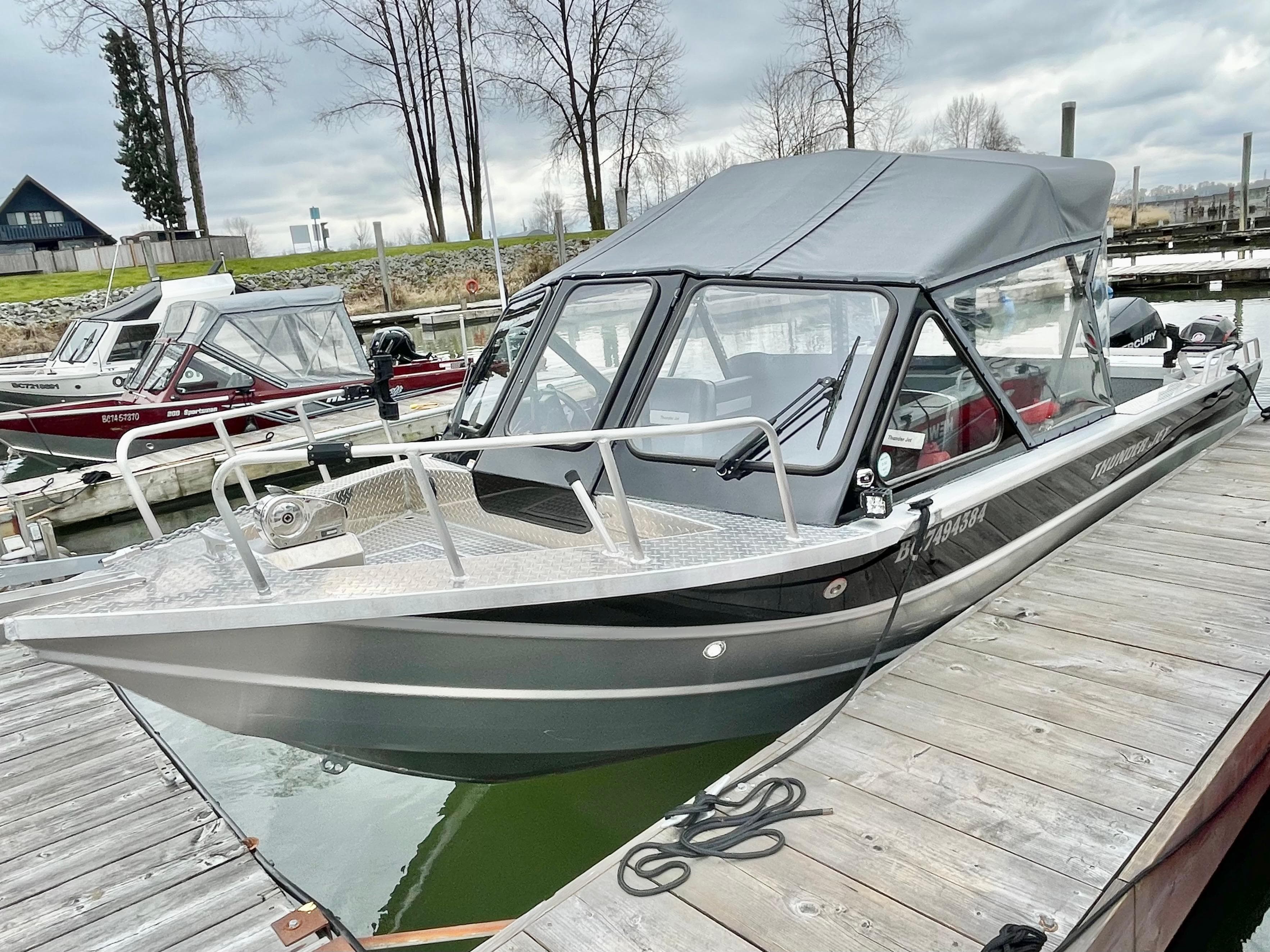 2021 Thunder Jet 210 Luxor Limited boat docked at marina, featuring sleek design and canopy.