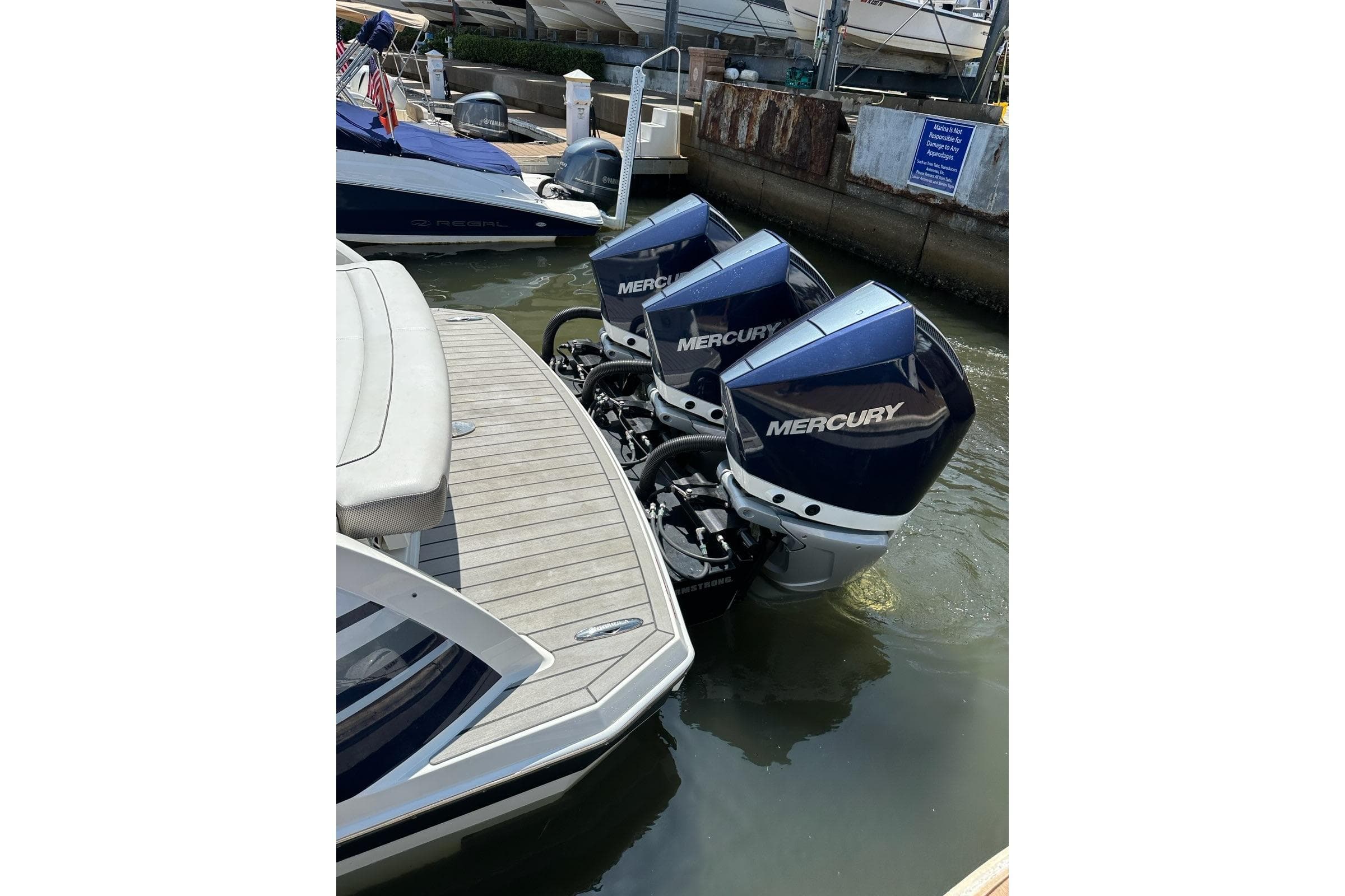 2021 Formula 330 Crossover Bowrider OB with triple Mercury outboard engines docked.
