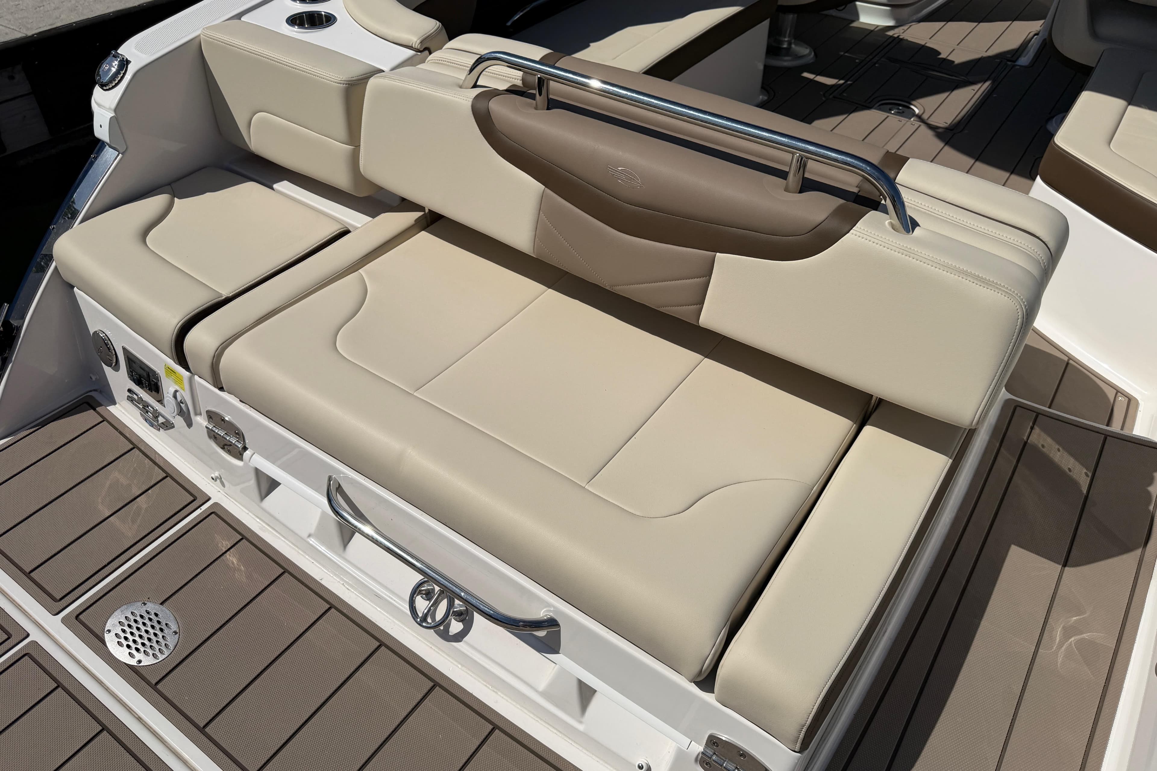 2024 Chaparral 287 SSX boat interior with beige seating and sleek design.