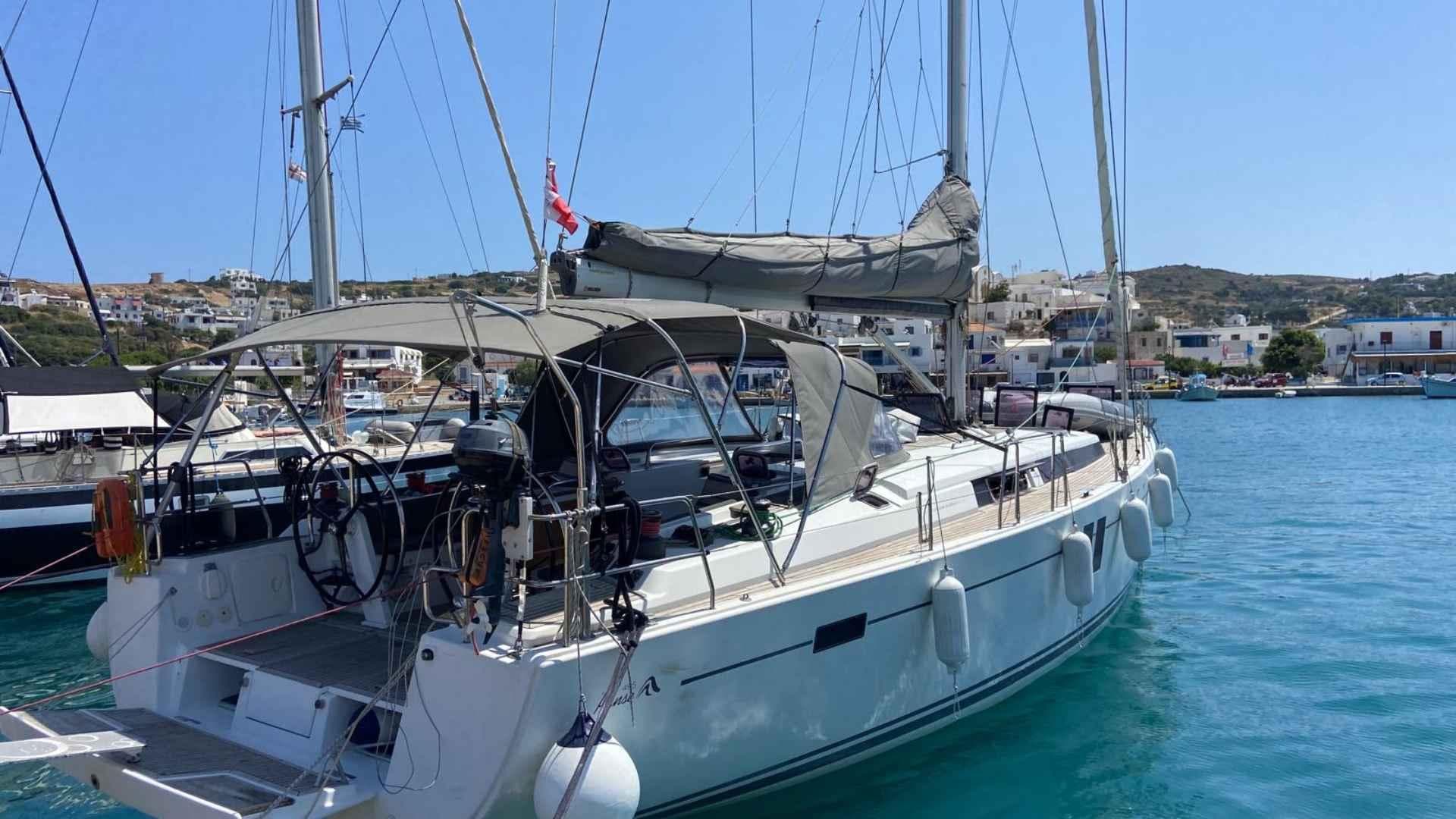 2012 Hanse 495 yacht docked in a scenic marina, clear blue water.