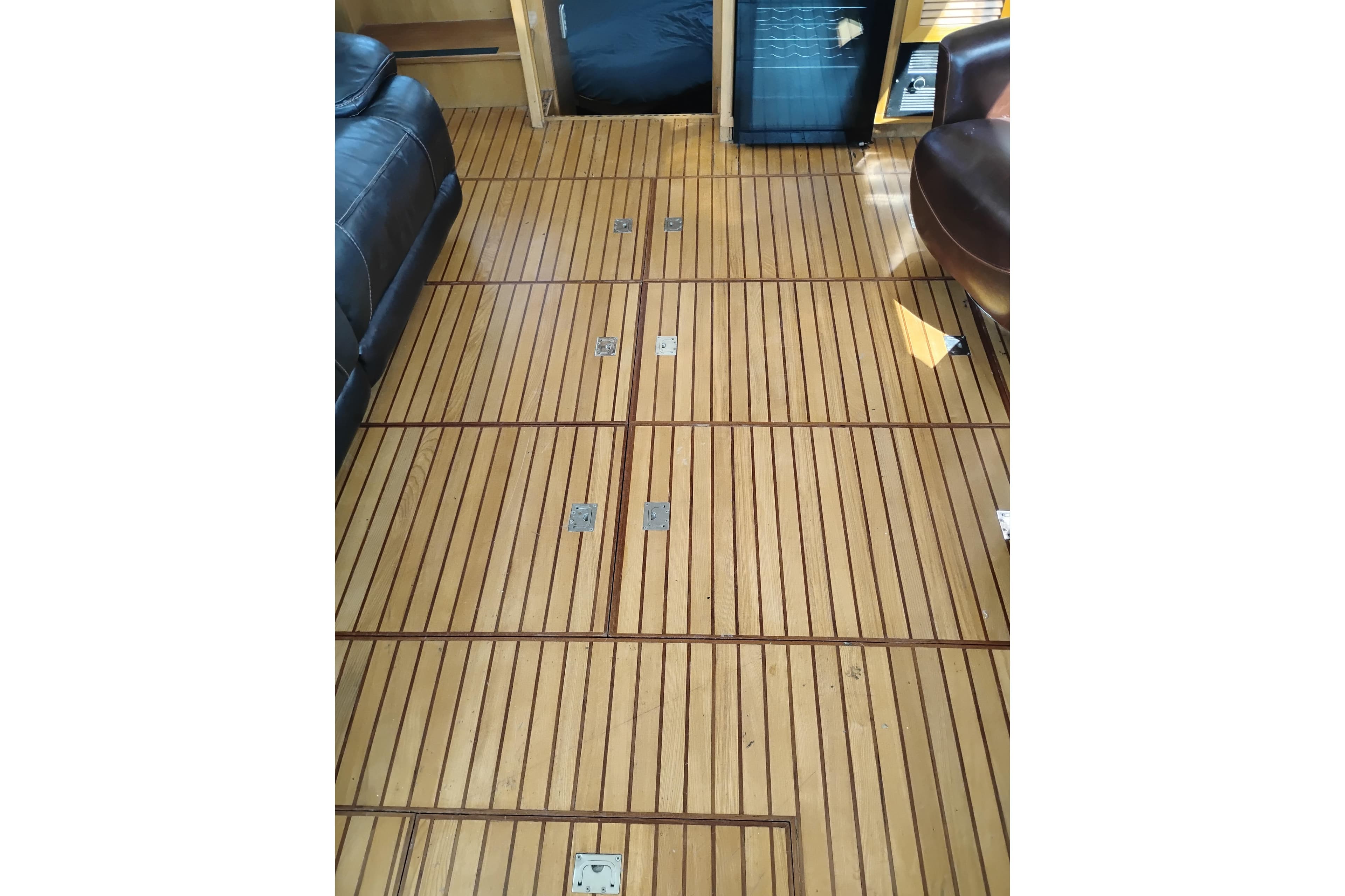 Teak flooring inside 1988 PT 52 AFT Cabin Motor Yacht, featuring sleek wood paneling.