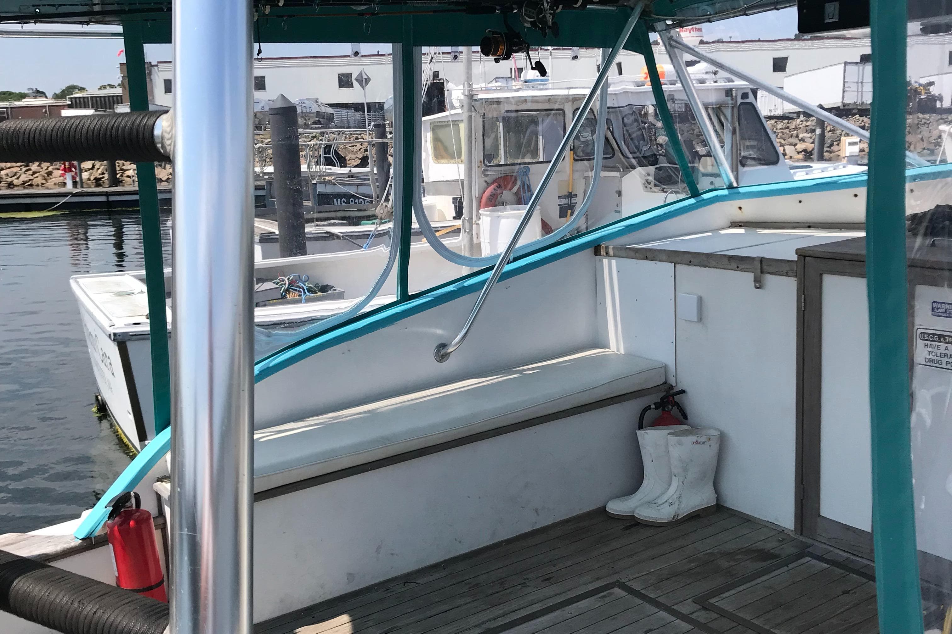 1988 JC Provincetown boat interior at a marina with white boots and safety equipment.