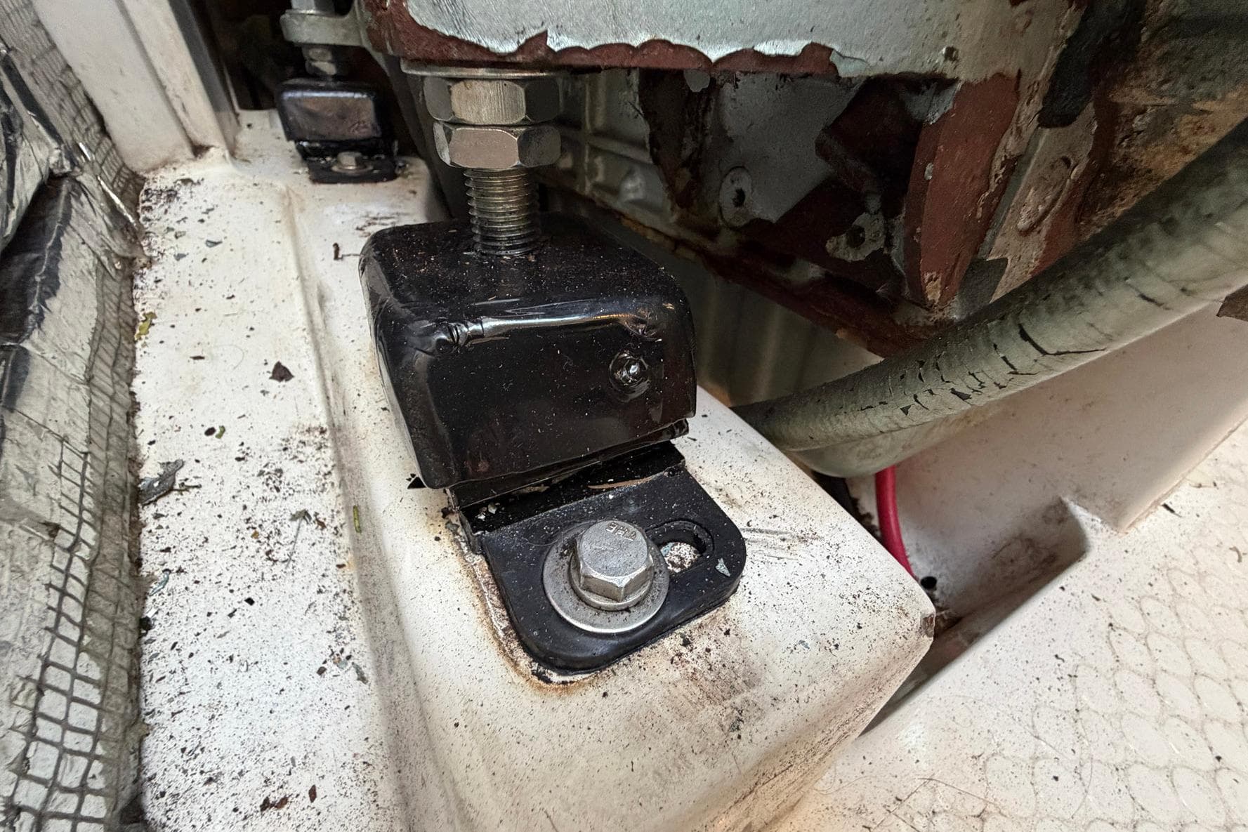 Engine mount detail on a 2001 Catalina 36 MkII sailboat, showing bolts and surrounding area.