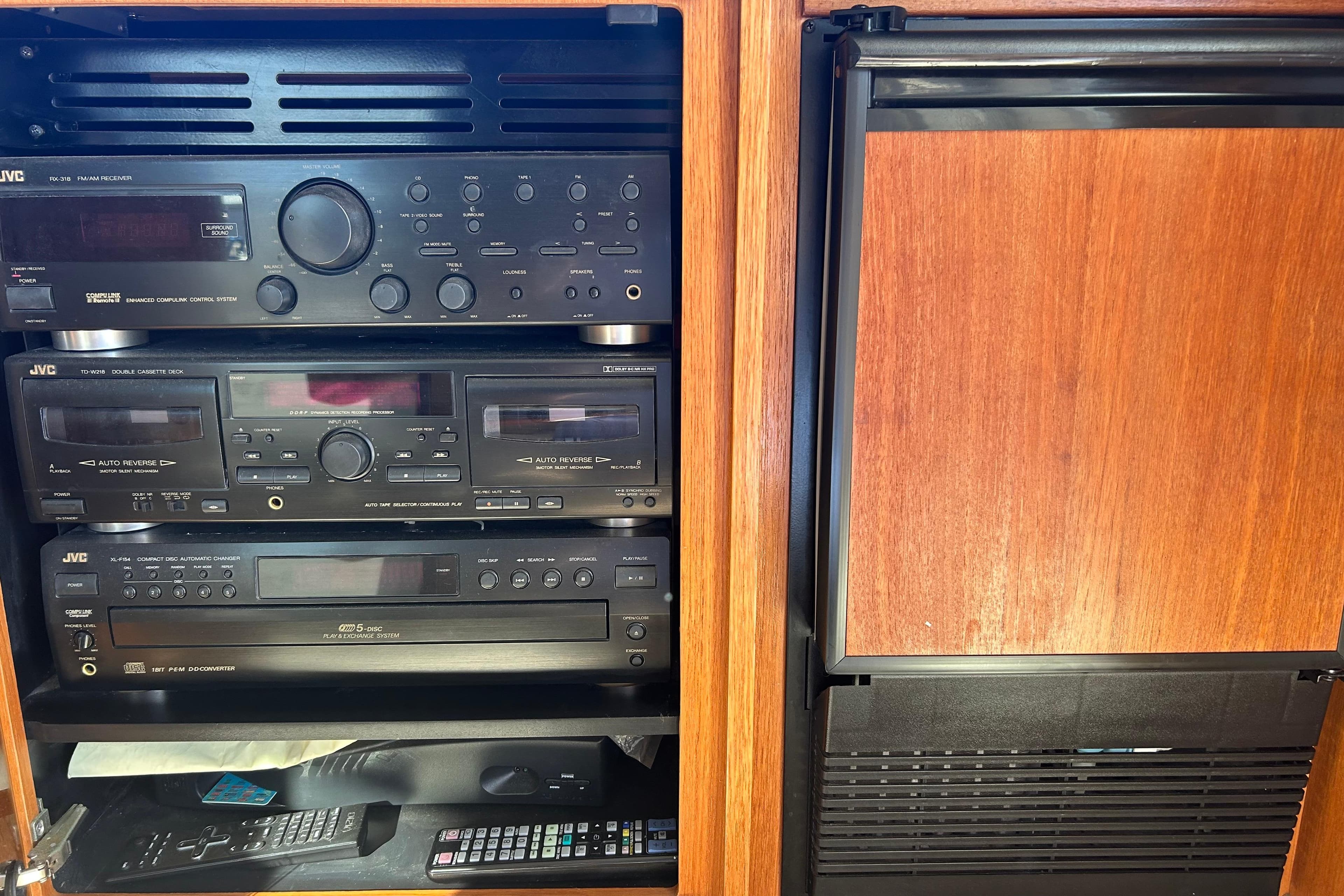 1998 Bayliner 5788 Pilot House Motoryacht audio system with JVC components and wooden cabinetry.