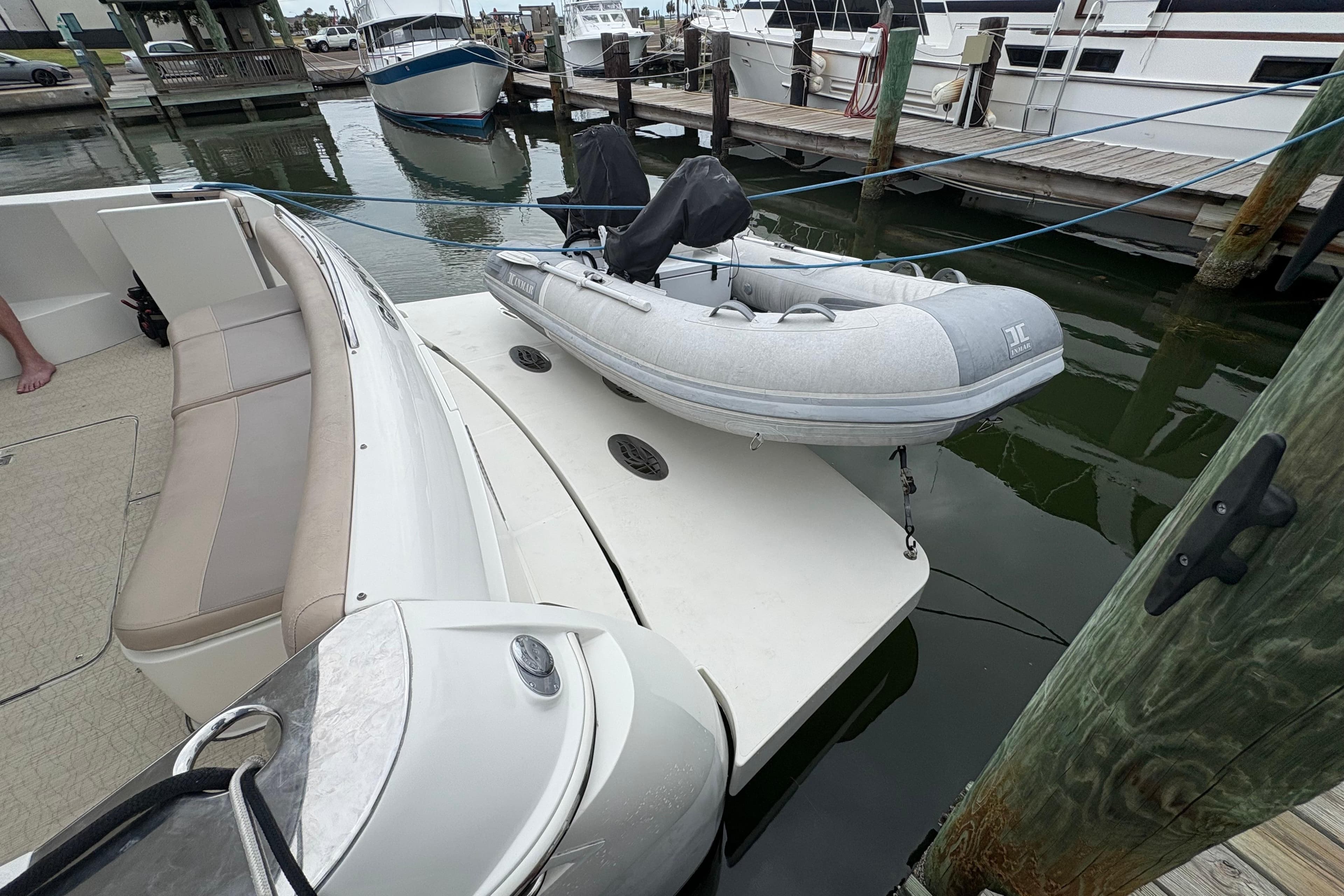 2004 Carver 560 Voyager with inflatable dinghy docked at marina.