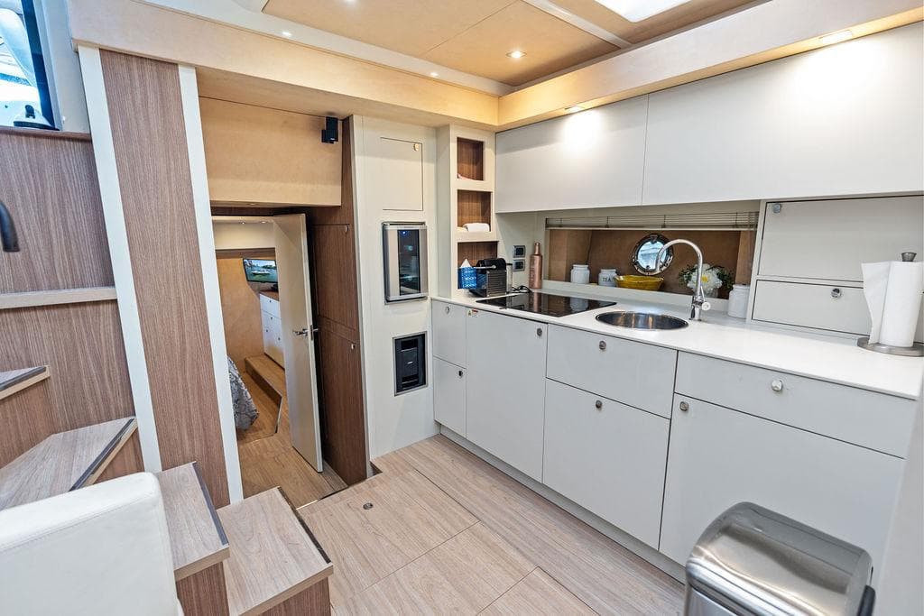 Luxurious 2014 Cranchi 56 HT yacht interior with modern kitchen and sleek cabinetry.