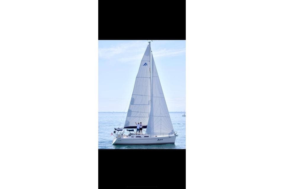 2005 Hanse 342 sailboat on calm waters with two people onboard.