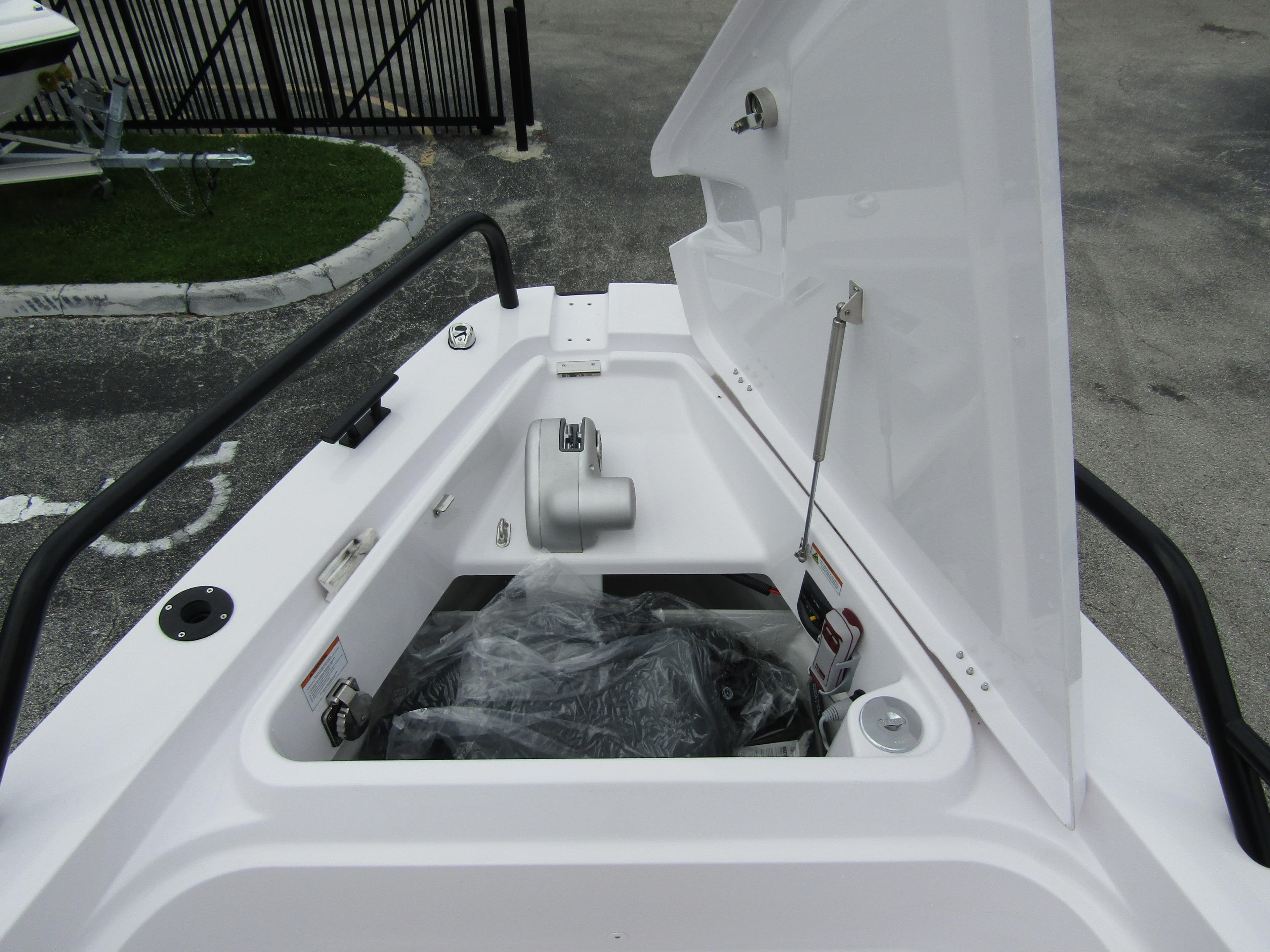 2024 Axopar 37XC CROSS CABIN storage compartment with open hatch.