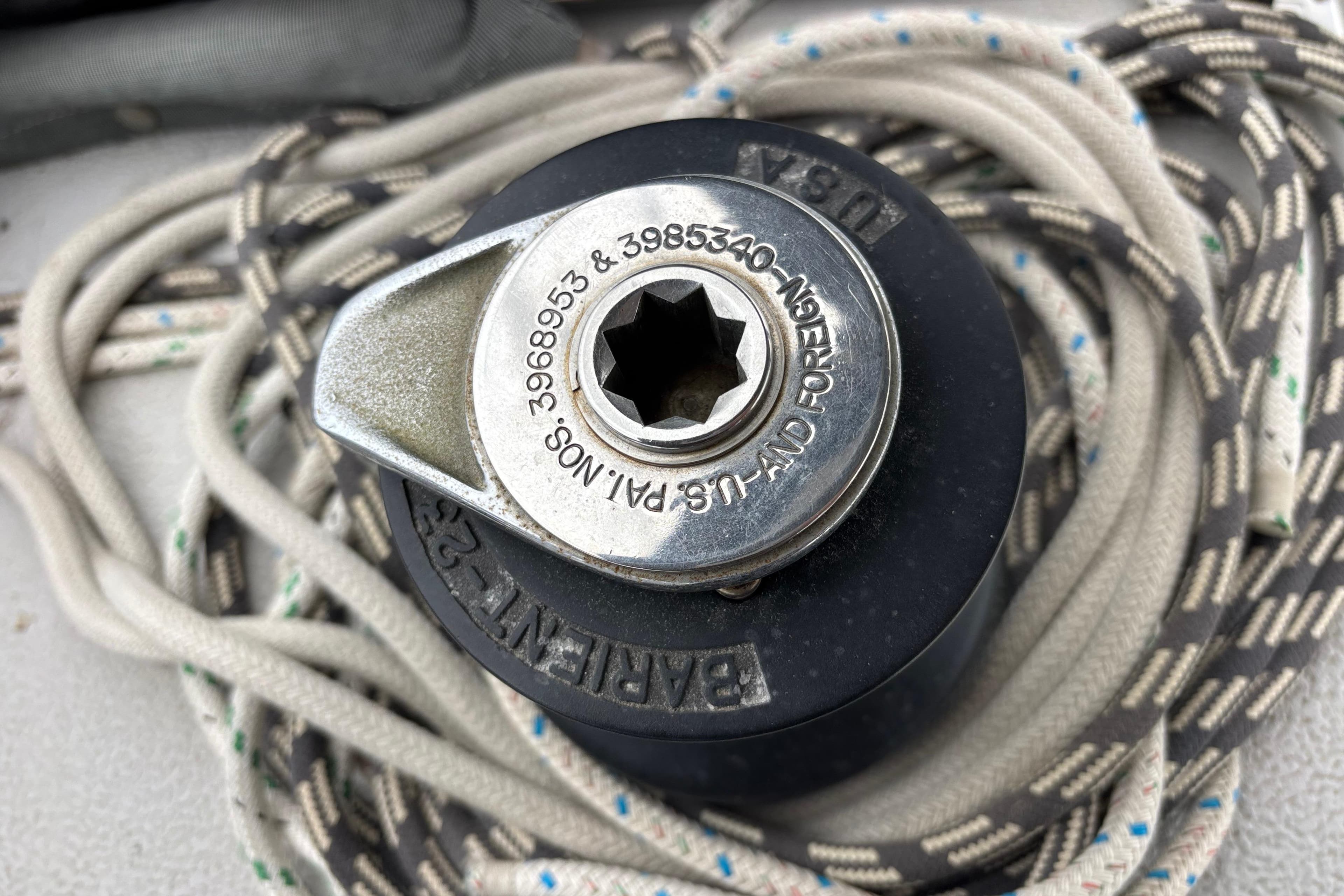 Winch mechanism on 1979 Islander Peterson 40 sailboat with coiled ropes.