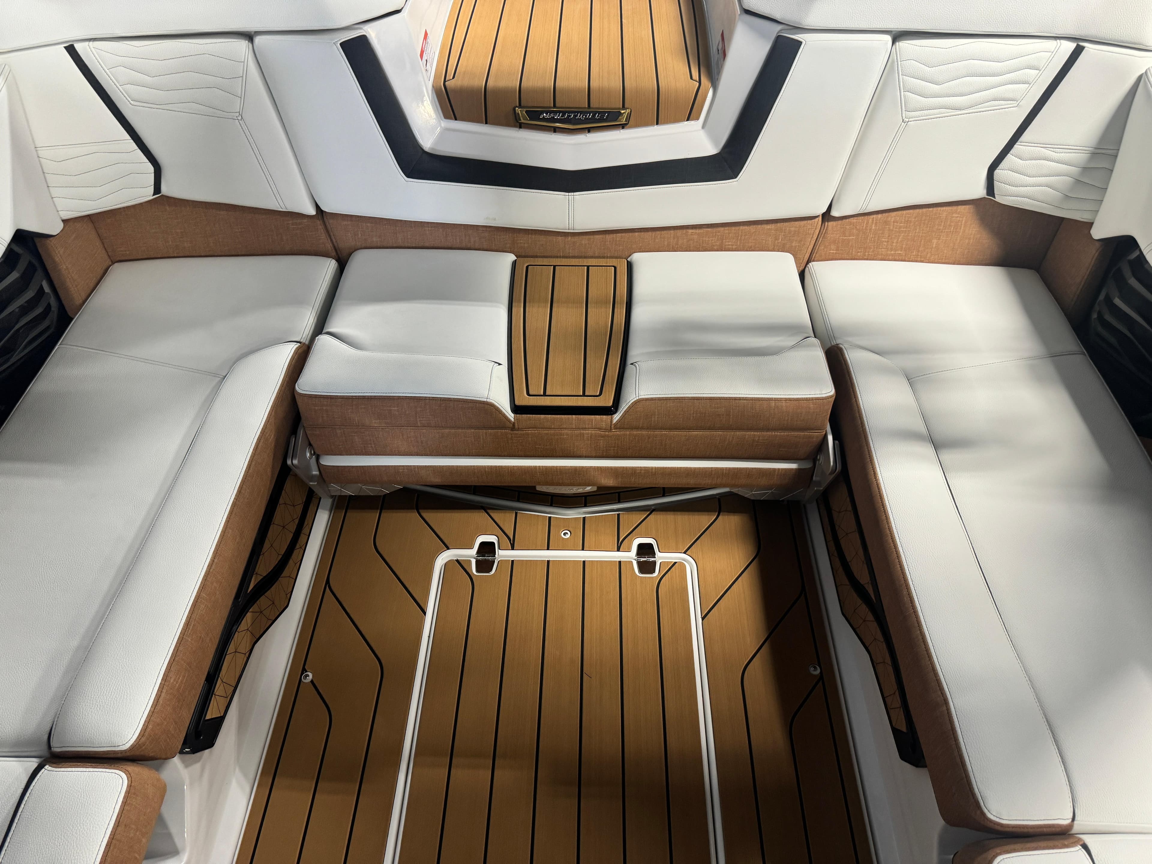 2025 Nautique Super Air G23 interior with white and tan seating, showcasing luxury design.