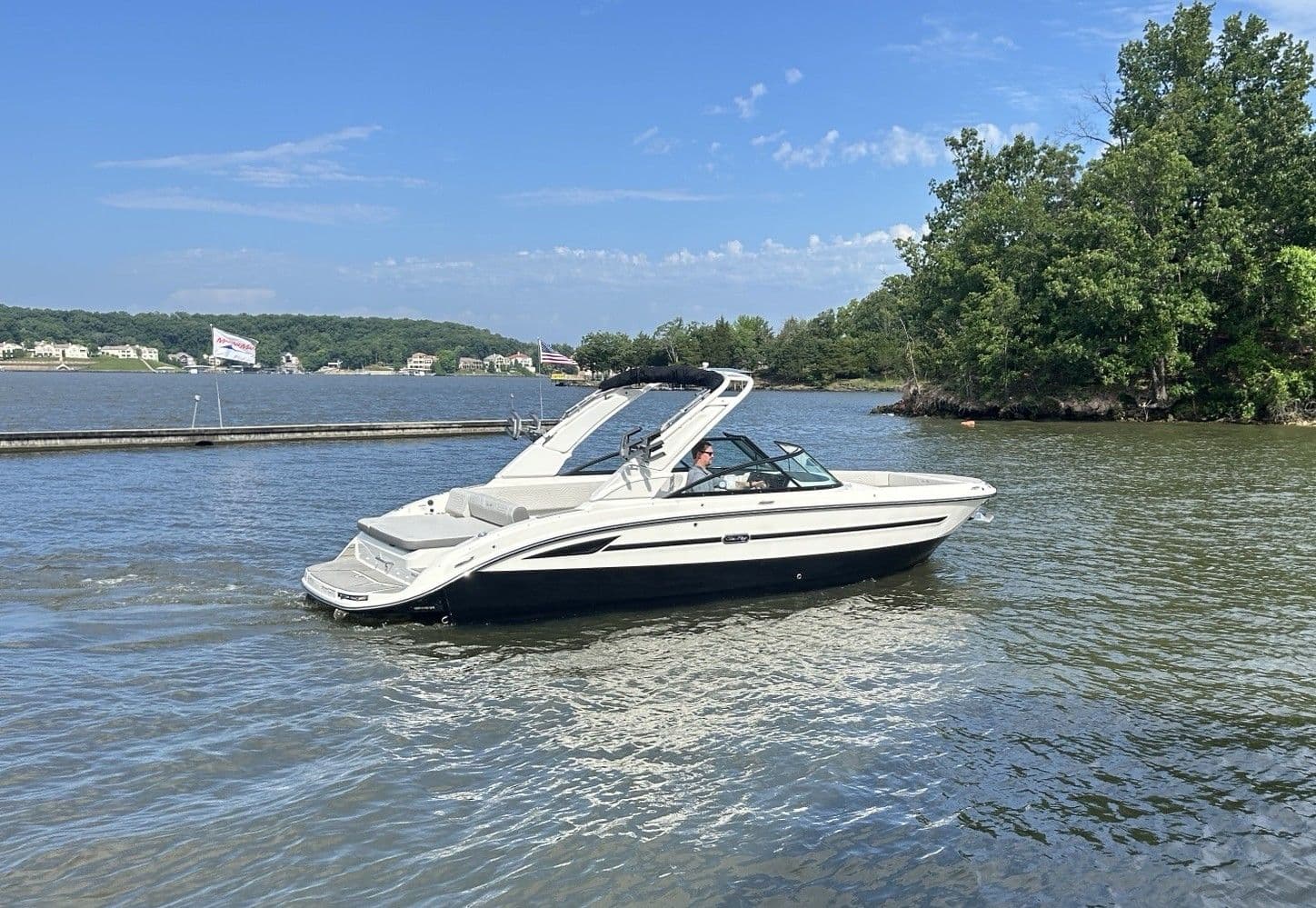 2025 Sea Ray SDX 270 Surf on a calm lake.
