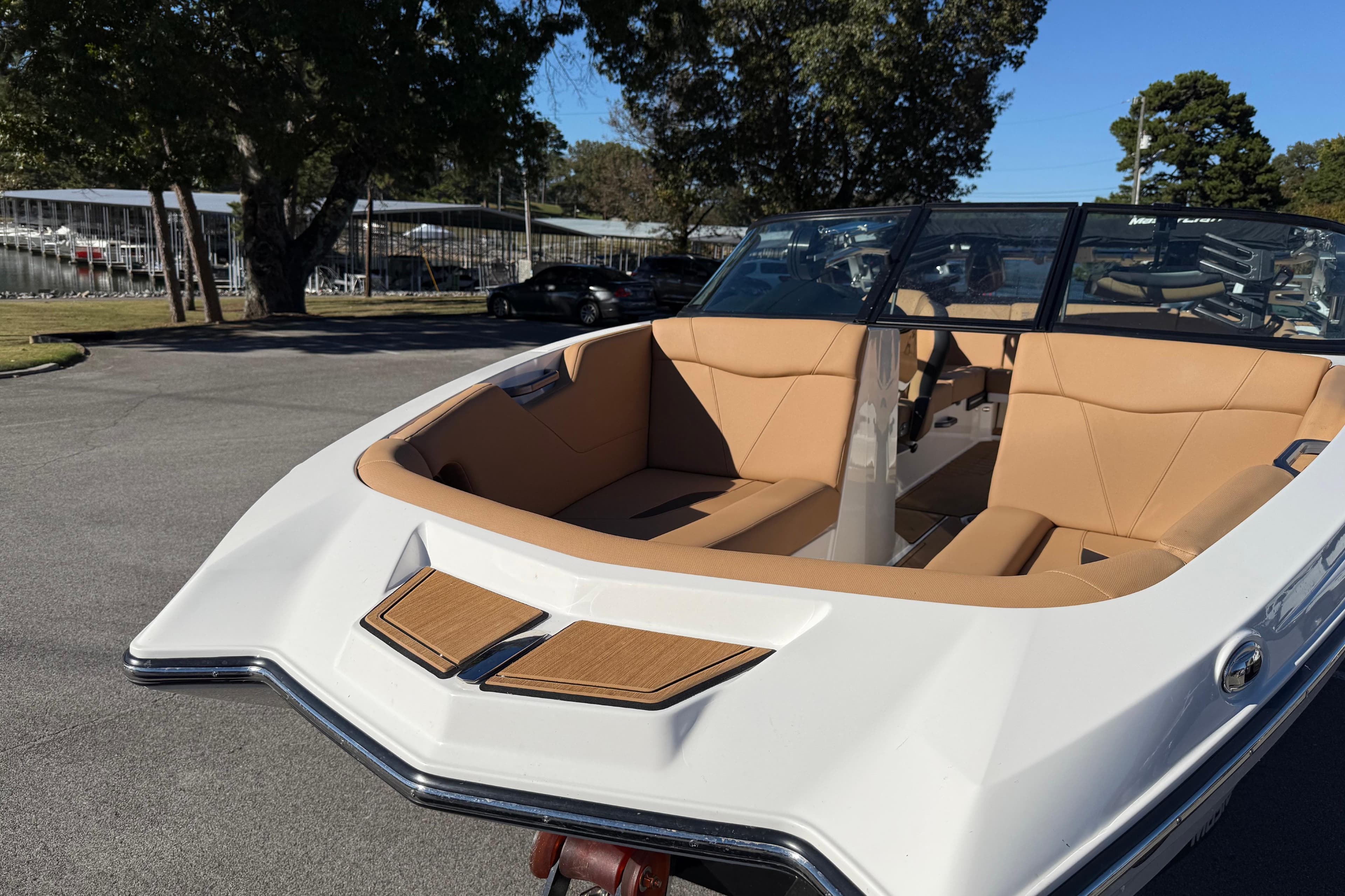 2022 MasterCraft NXT24 boat with tan interior, parked outdoors on a sunny day.