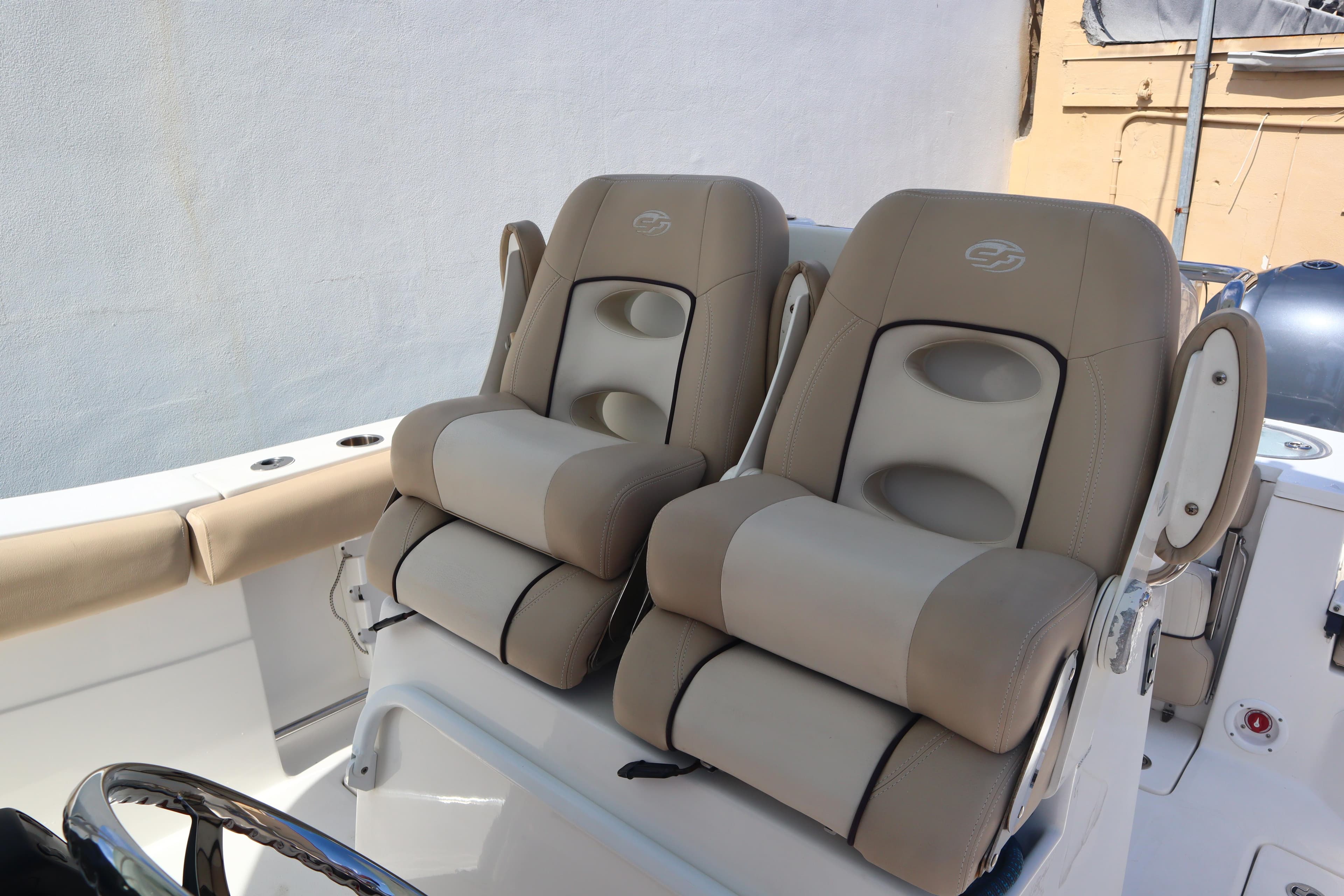 2017 Sea Fox 288 Commander boat seats, beige upholstery, dual captain's chairs.