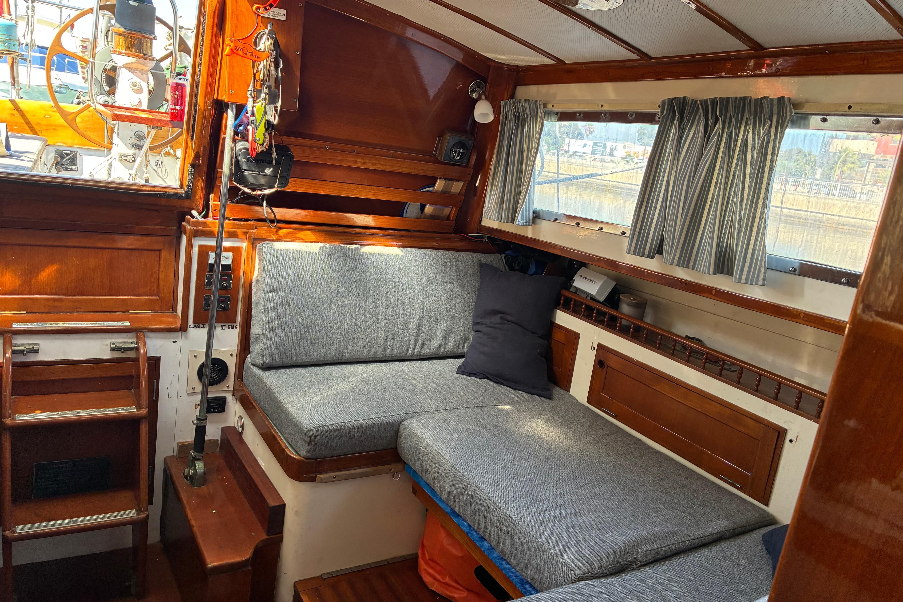 1974 Cheoy Lee Luders Offshore 28 yacht interior with cozy seating and wooden accents.